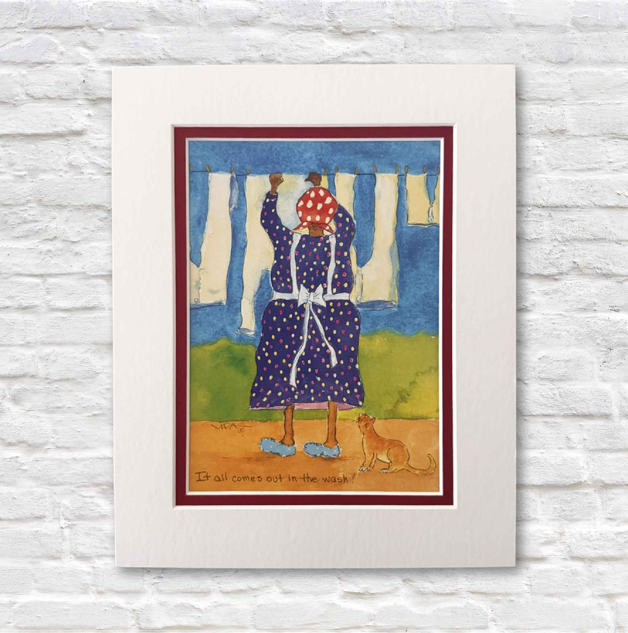 Matted artwork of a woman in a polka dot dress with a cat, on a white brick wall.