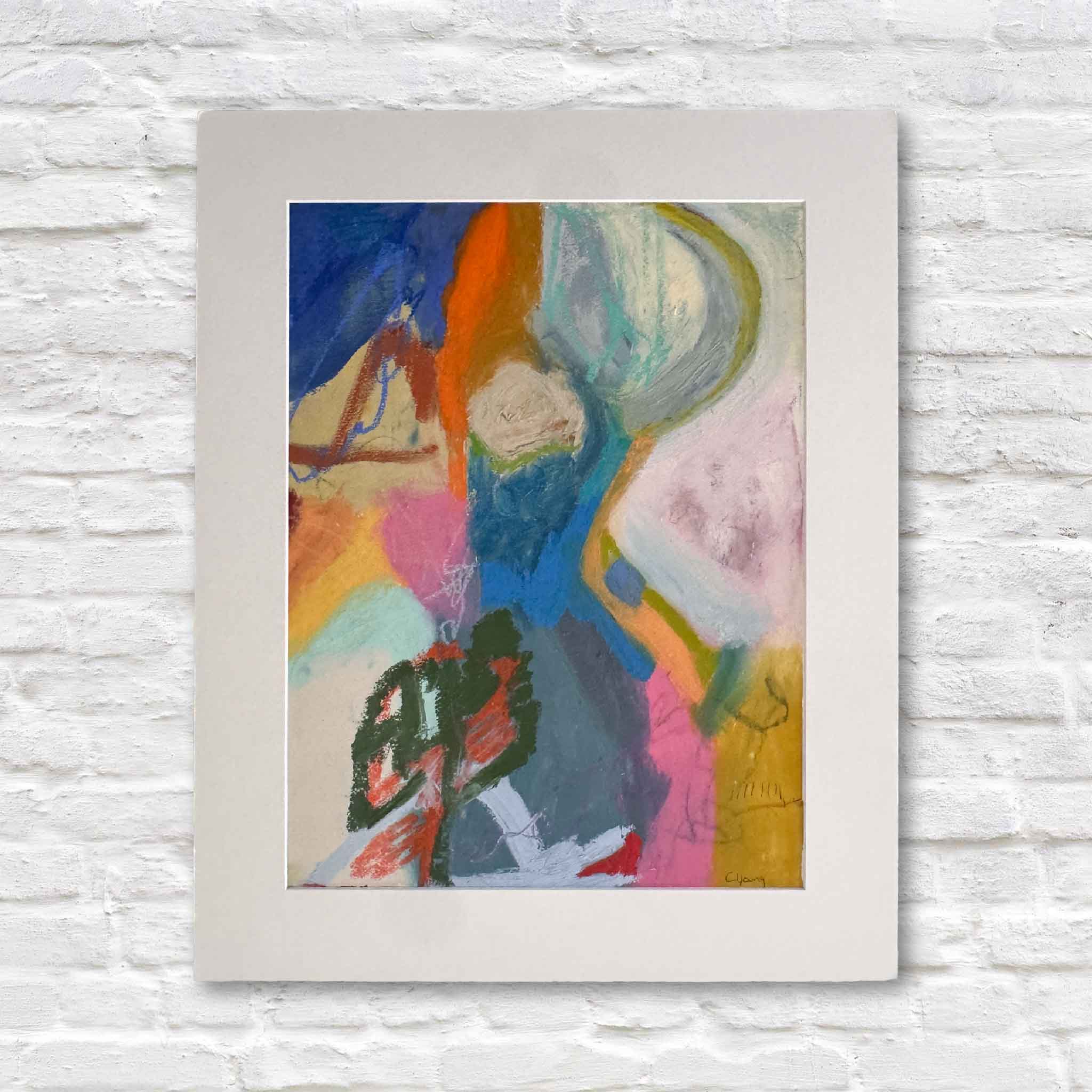 matted abstract painting with colorful brush strokes on a white brick wall.