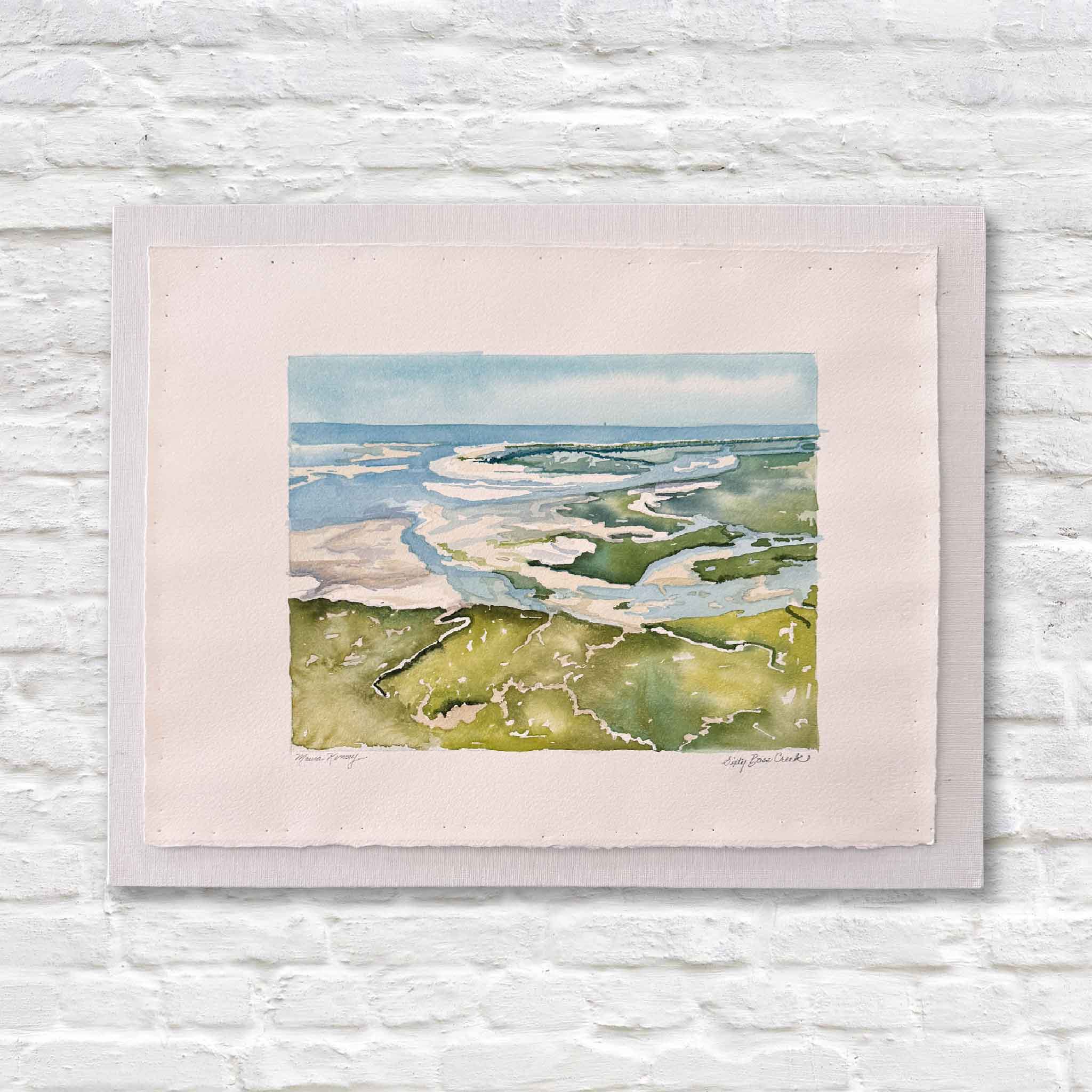 Watercolor painting of a north inlet landscape with marsh, ocean, and blue sky on a white brick wall.