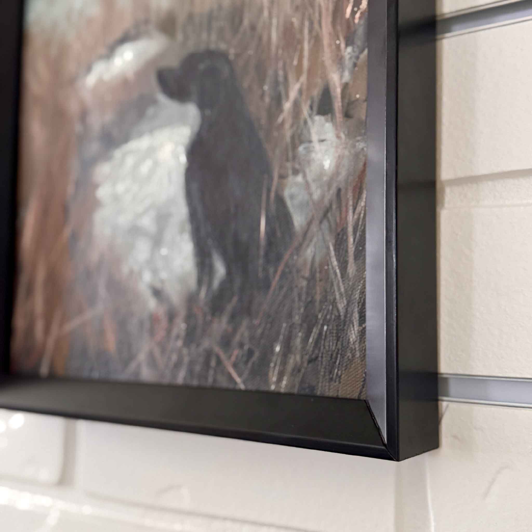 A black lab sits watchfully at the water’s edge, eyes trained on the open sky in anticipation. Original oil painting by local artist in Georgetown, South Carolina