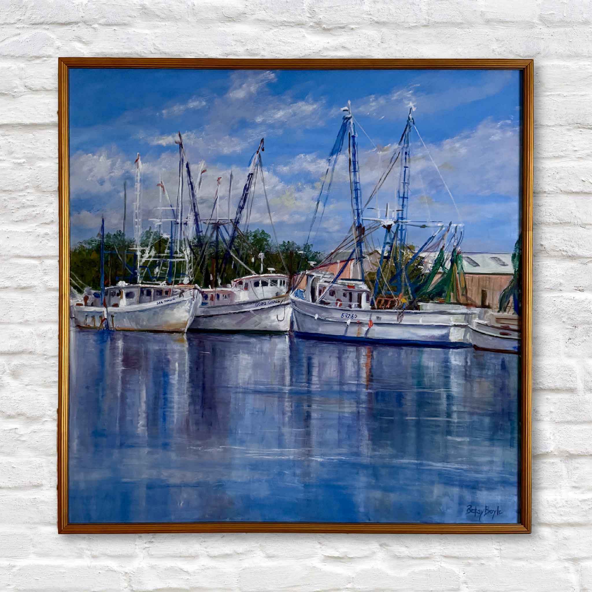 Framed painting of shrimp boats docked at a marina with a blue sky.