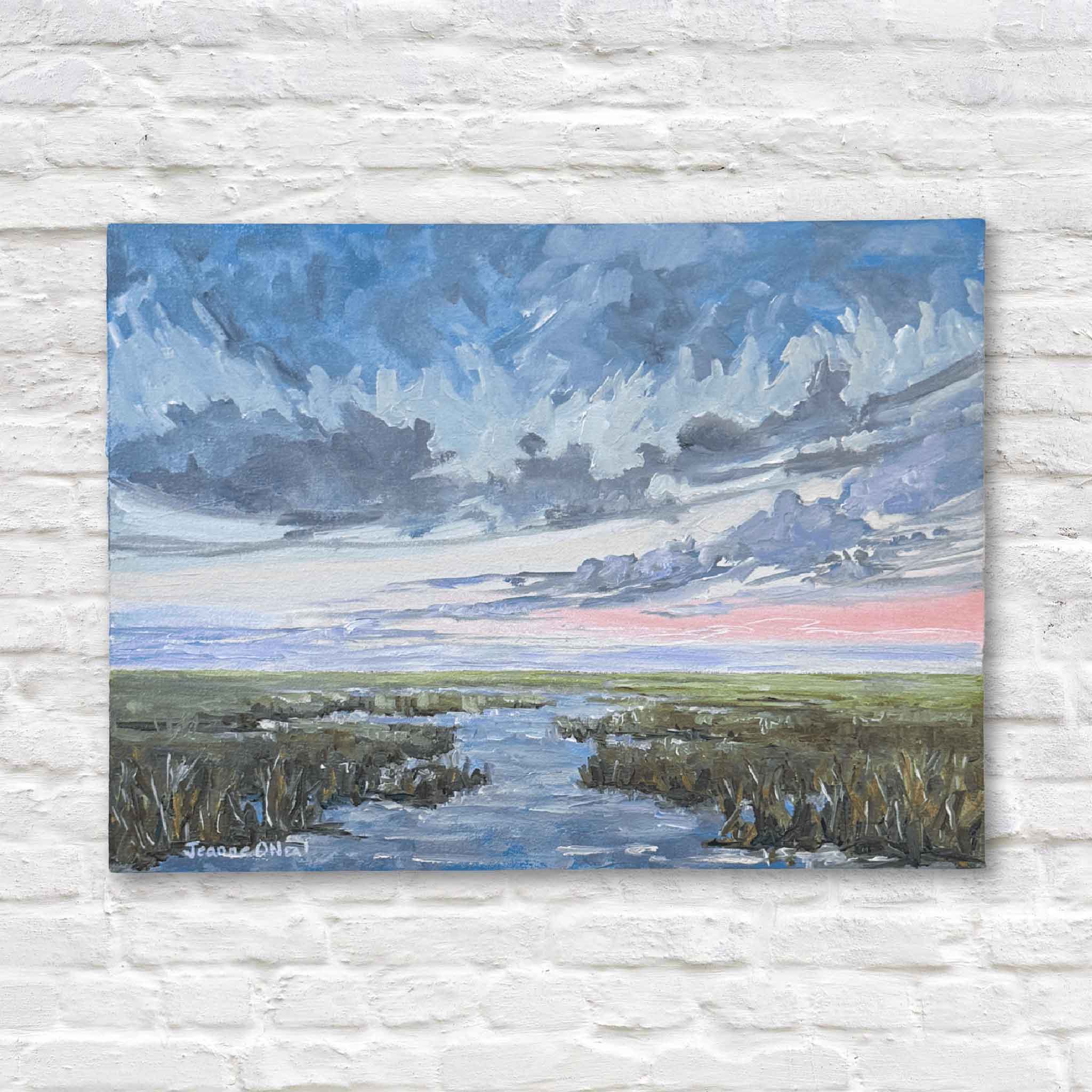 Painting of a landscape with water, sky, and grass on a textured white wall.