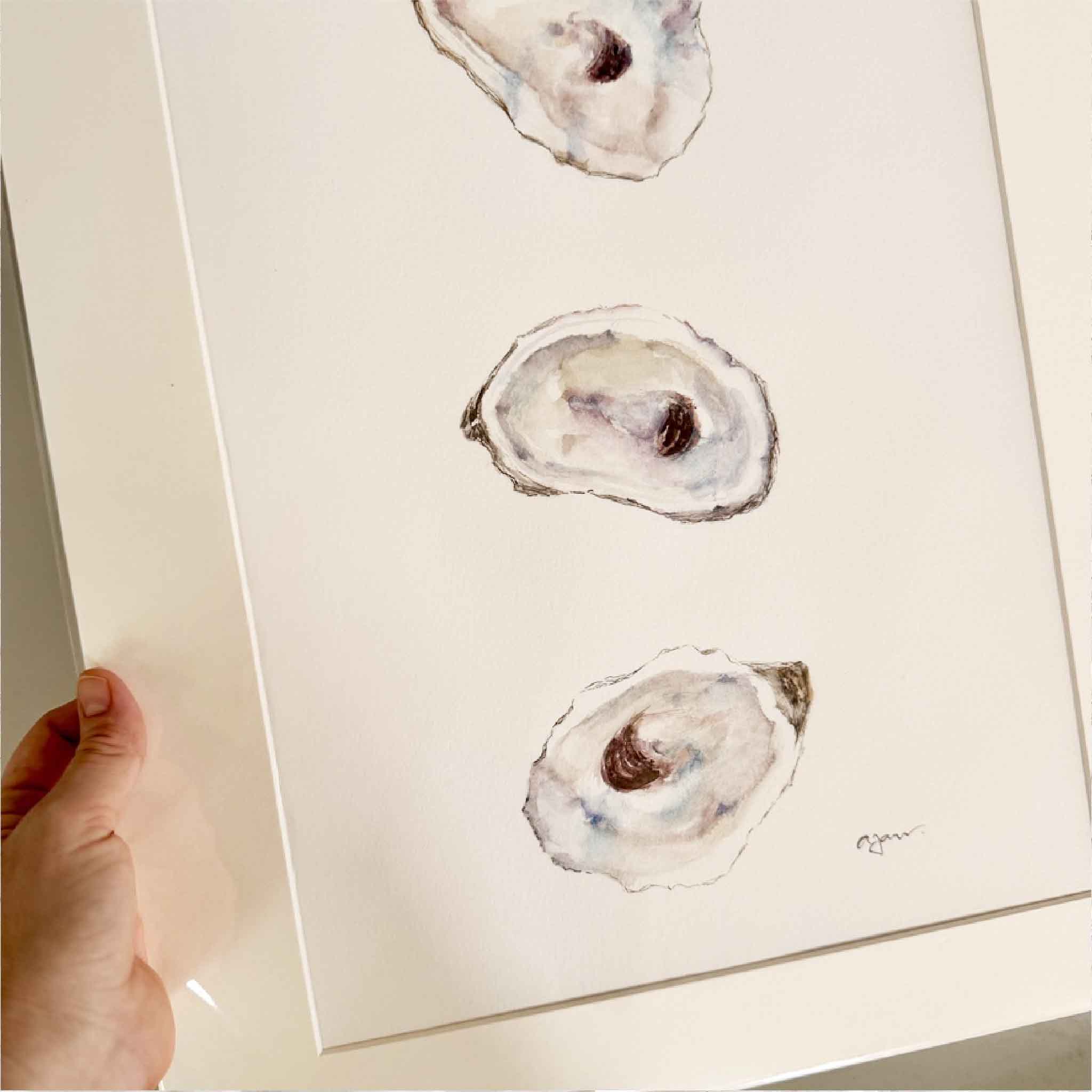 Hand-painted watercolor artwork of three oyster shells in soft gray, lavender, and blue hues by Allison Farr, titled Iridescence, from her Lowcountry Jewels series.