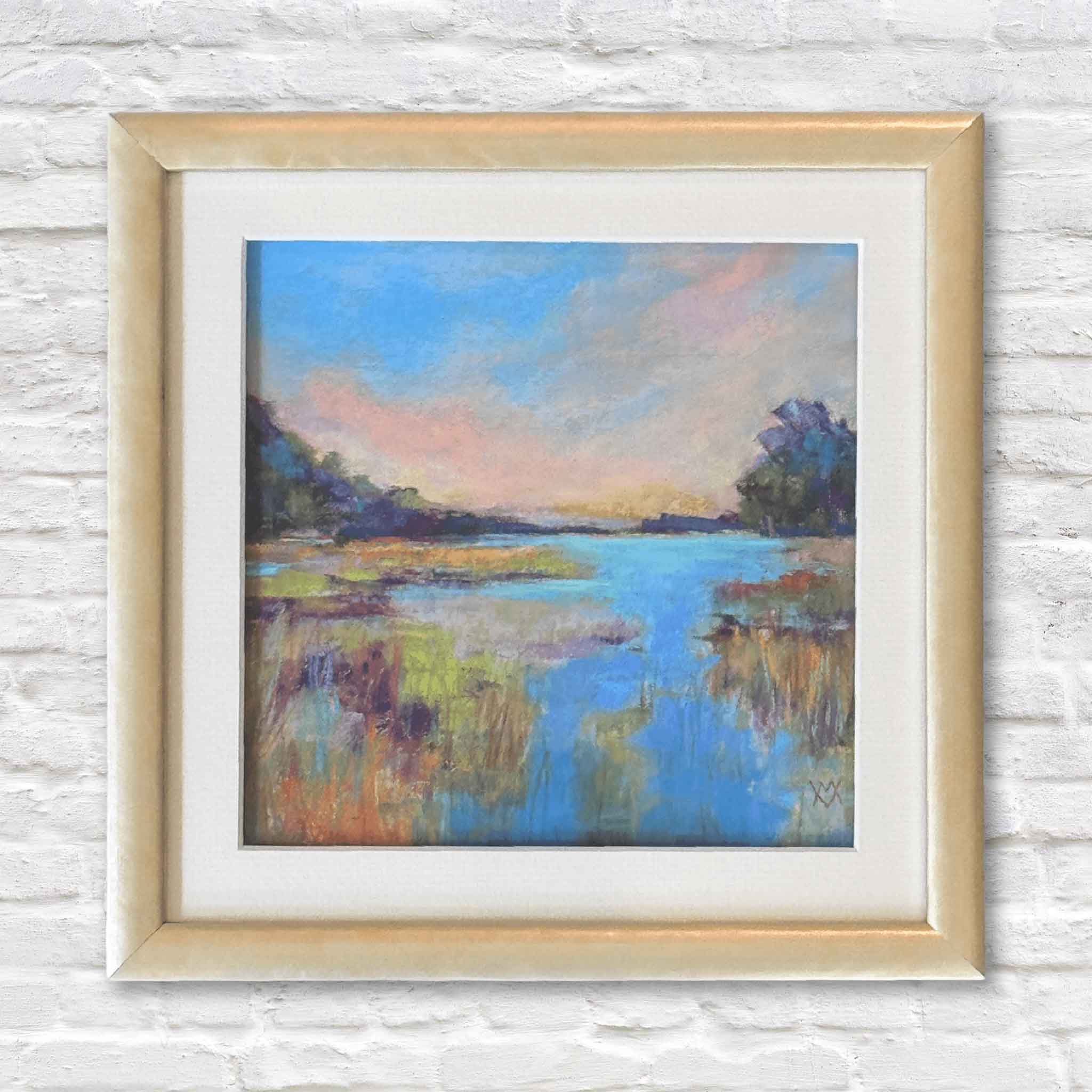 Framed painting of a landscape with a marsh and trees on a white brick wall.