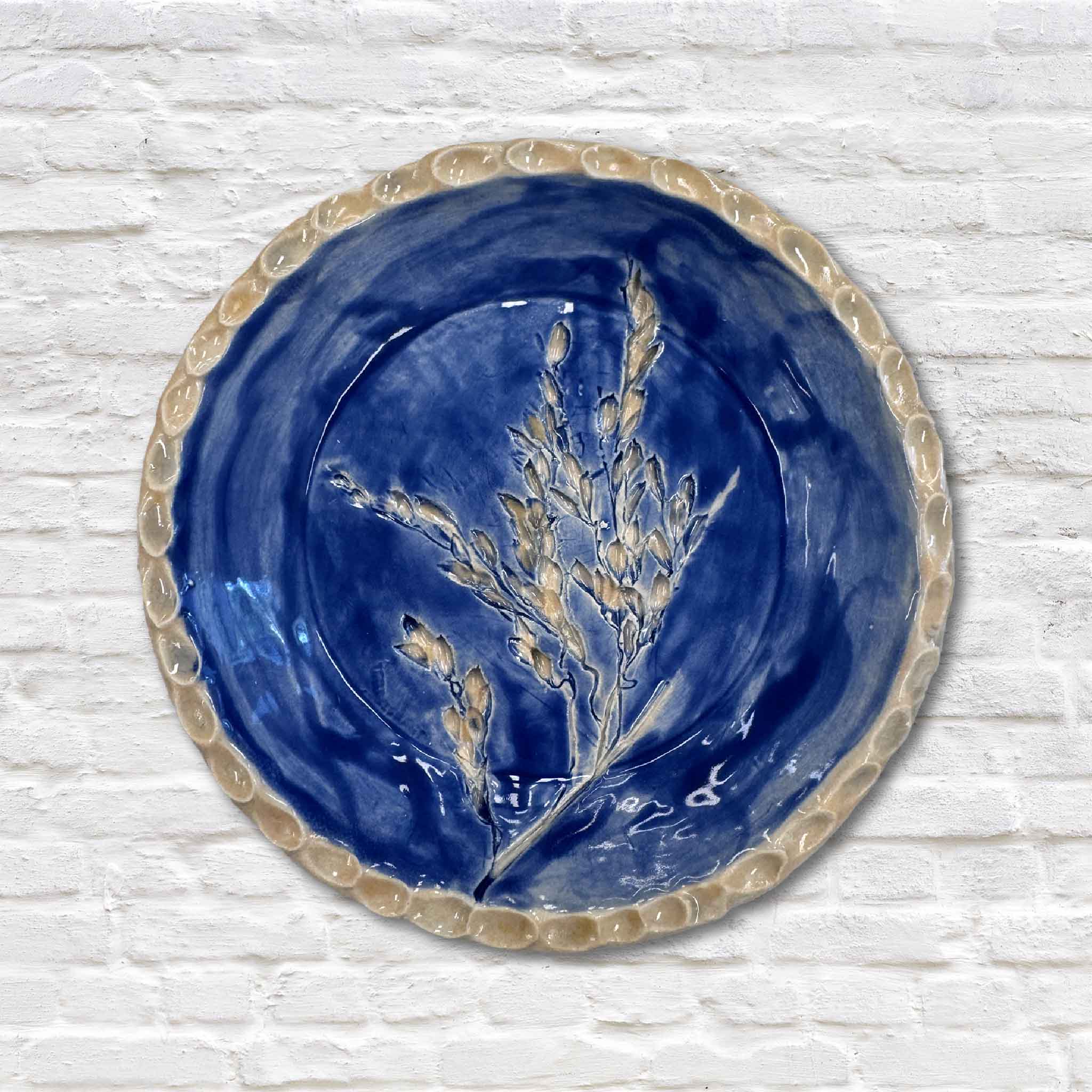 indigo blue rice pottery dish on white brick wall