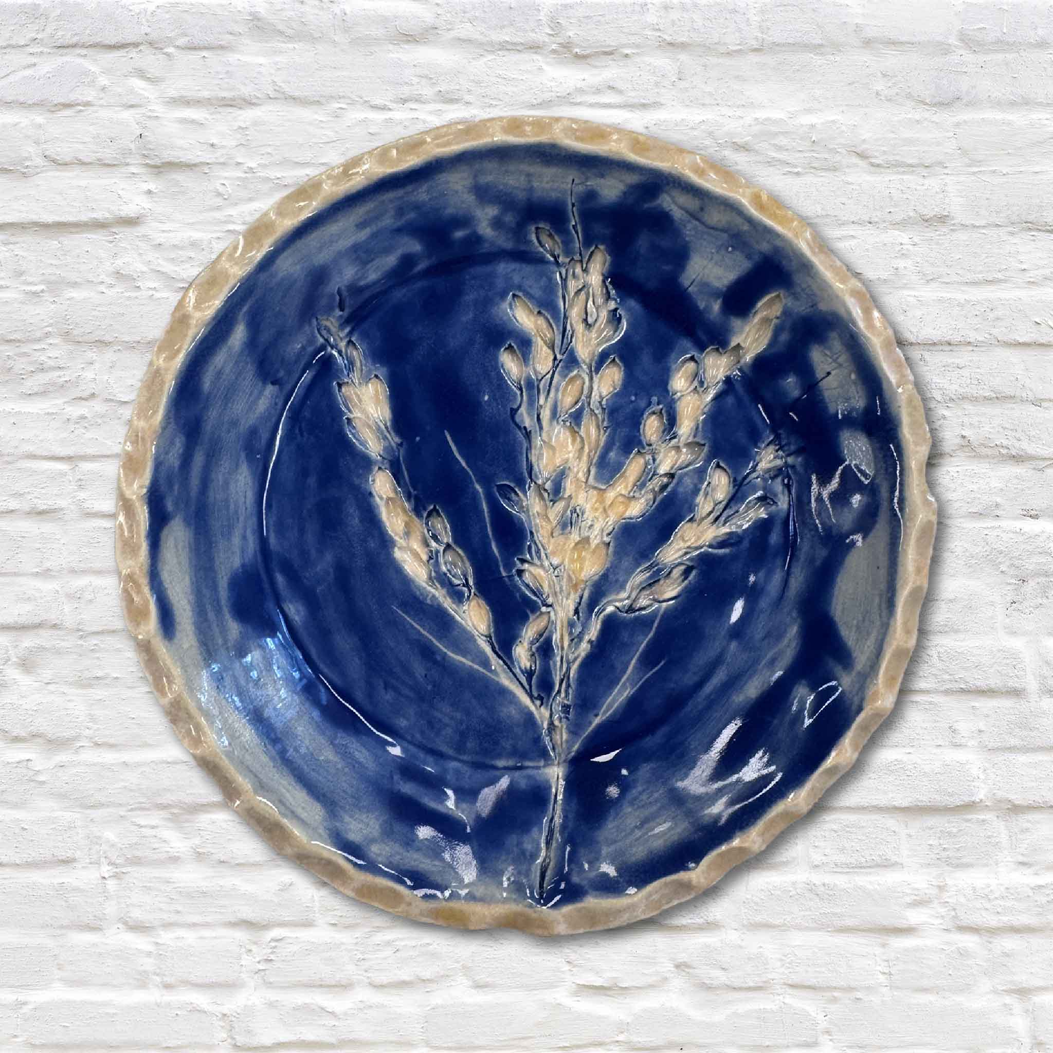 indigo blue rice pottery dish on white brick wall