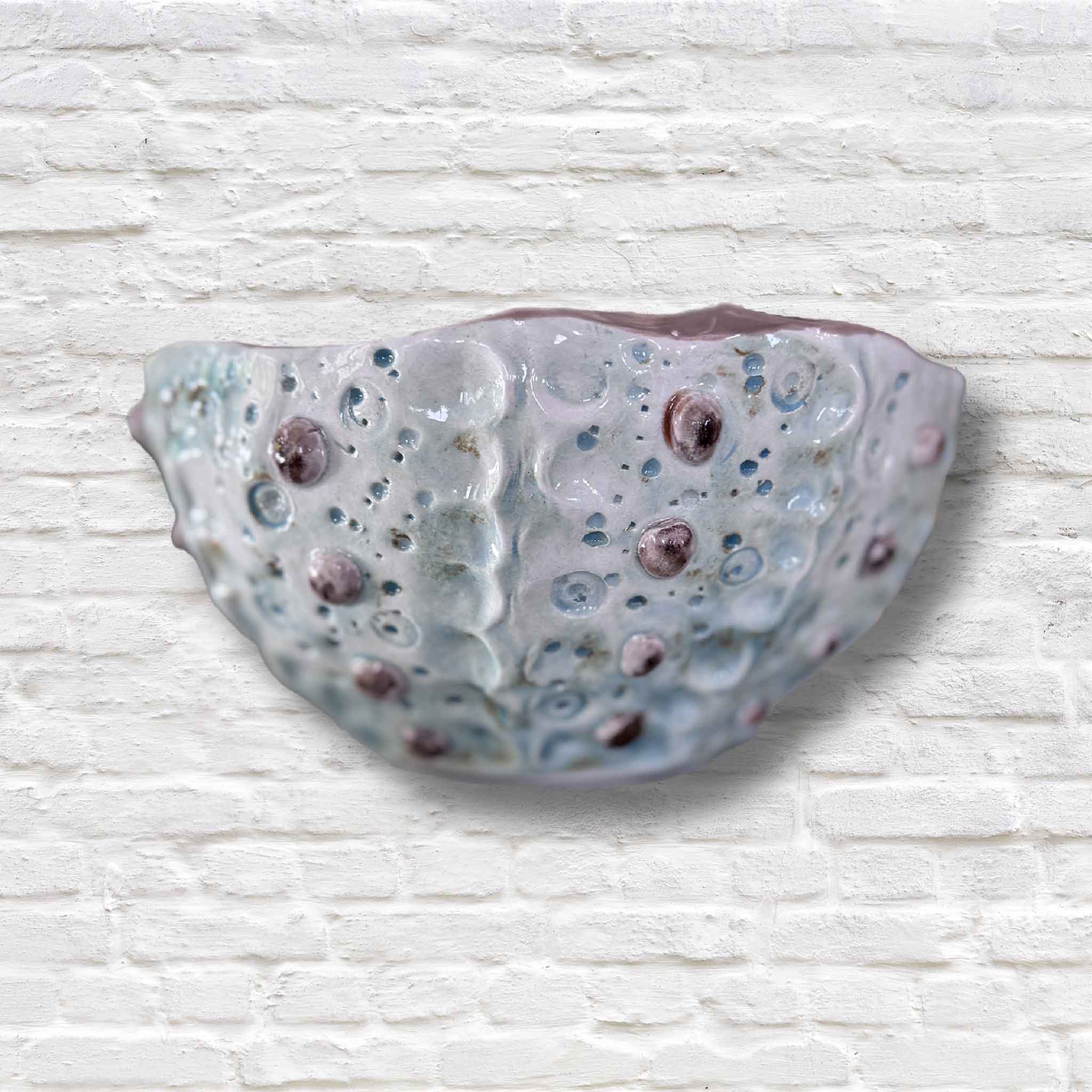 coastal pottery bowl on white brick wall