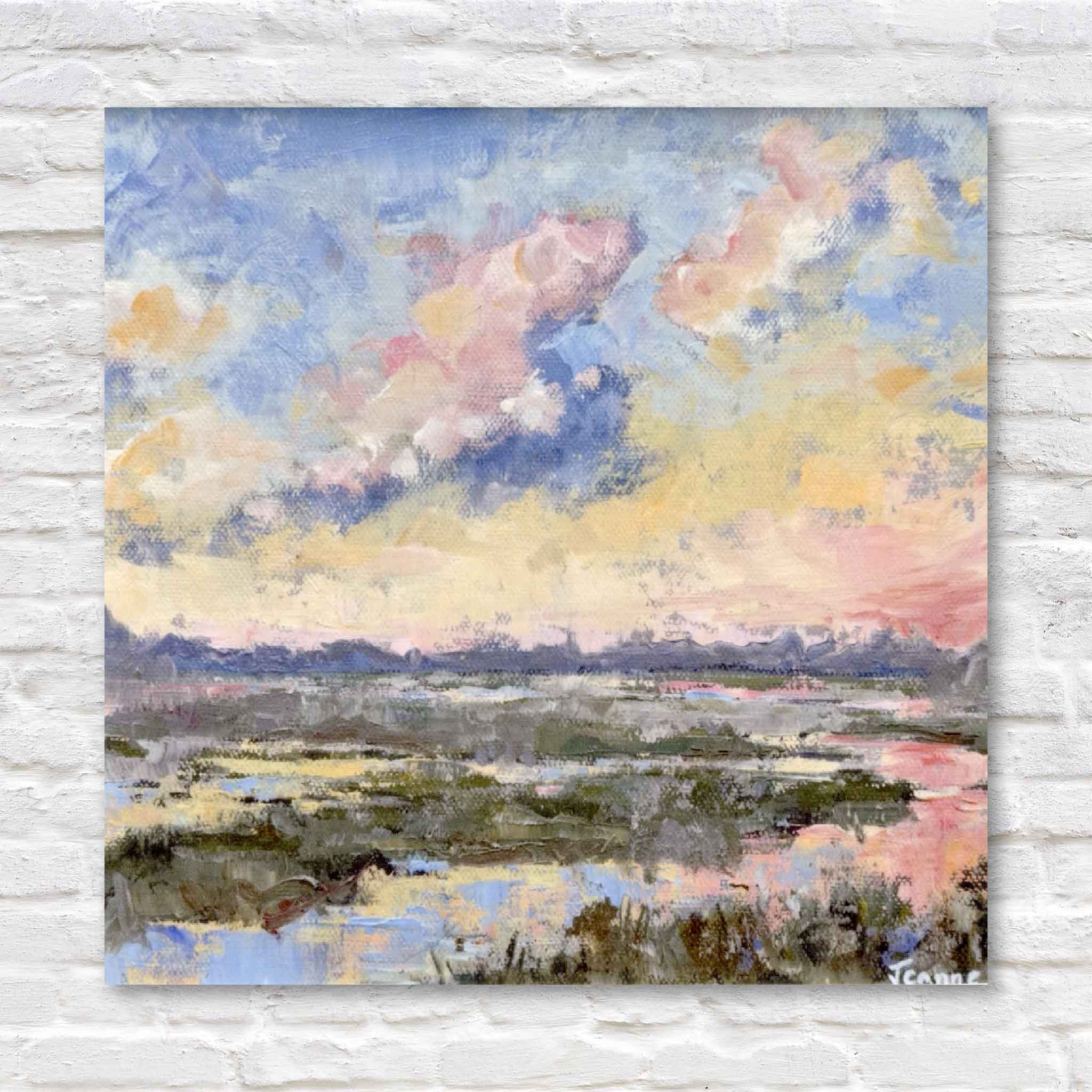 Painting of lowcountry marsh with colorful clouds on a white brick wall.
