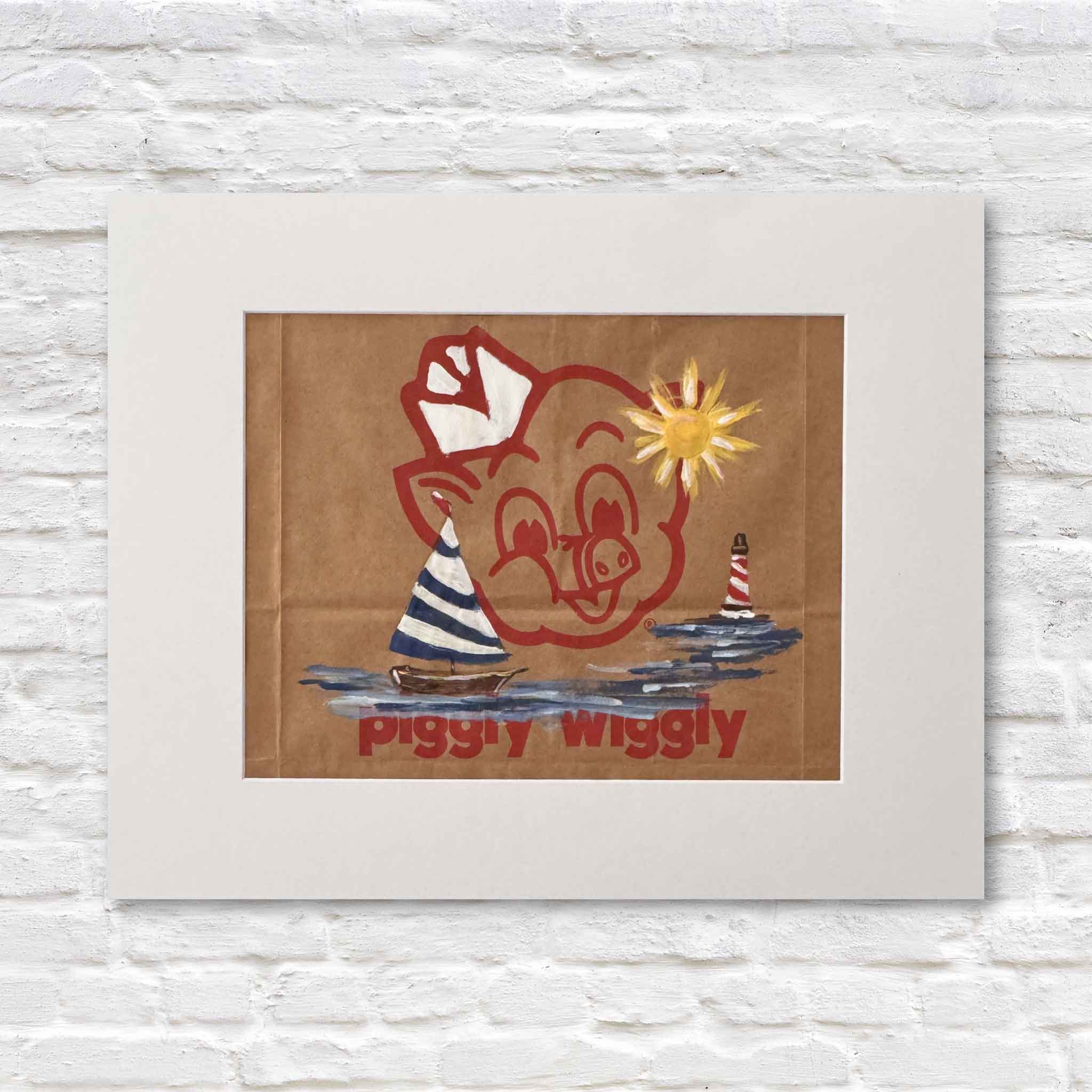 Mixed media artwork of acrylic painting of a sailboat and sun on a Piggly Wiggly shopping bag in a white matte against a white brick wall