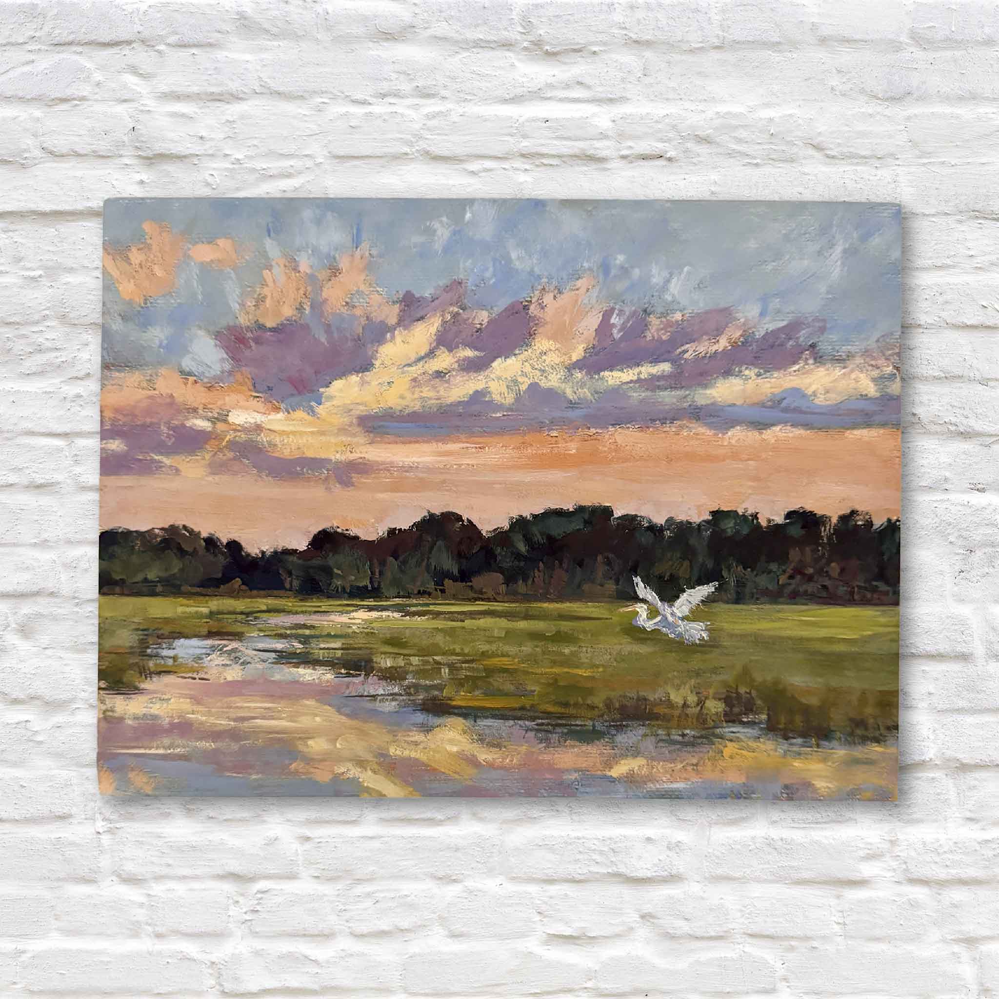lowcountry marsh art featuring a white egret mid-flight over a glowing sunset, against a white brick wall