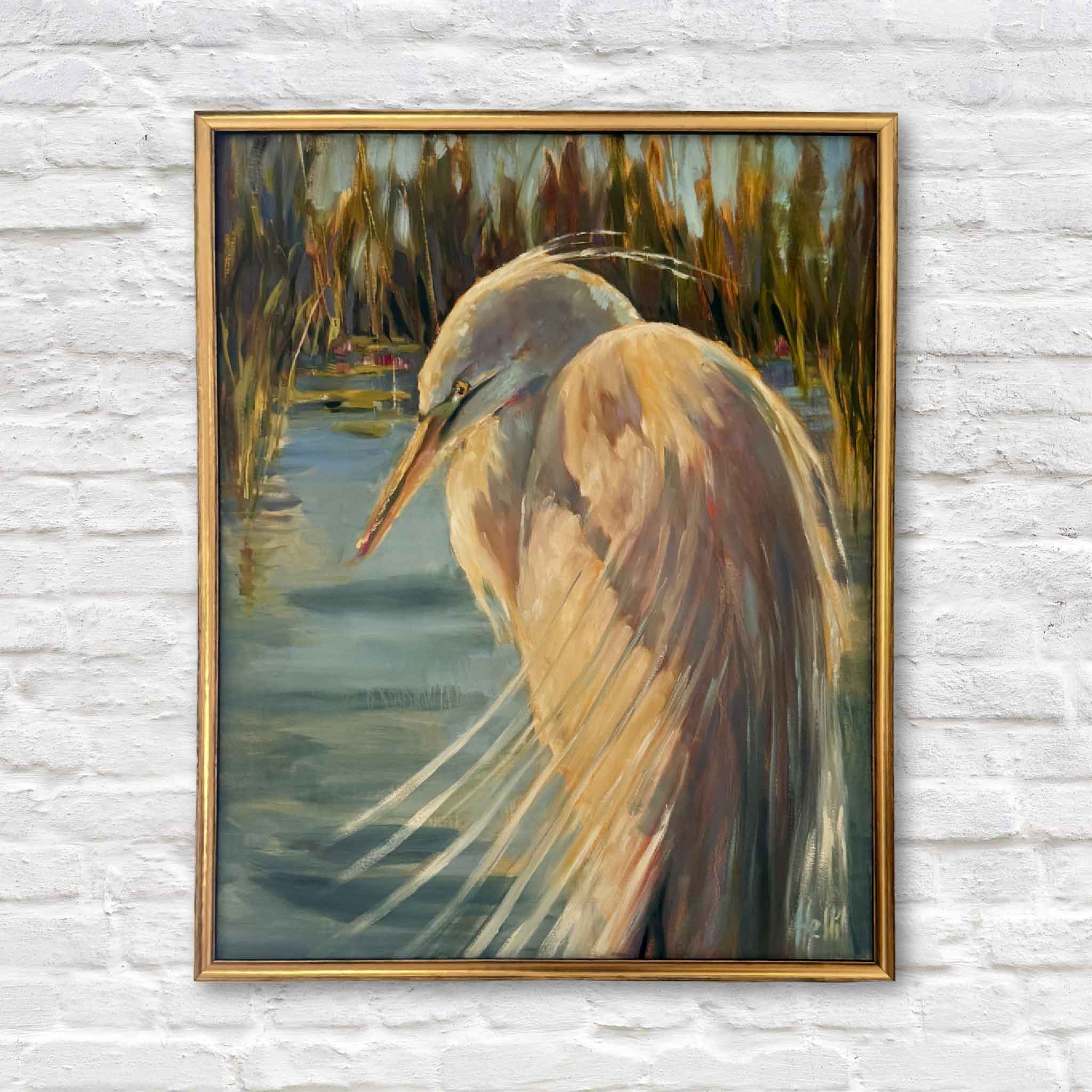 Framed painting of a heron in a natural setting on a textured white wall.