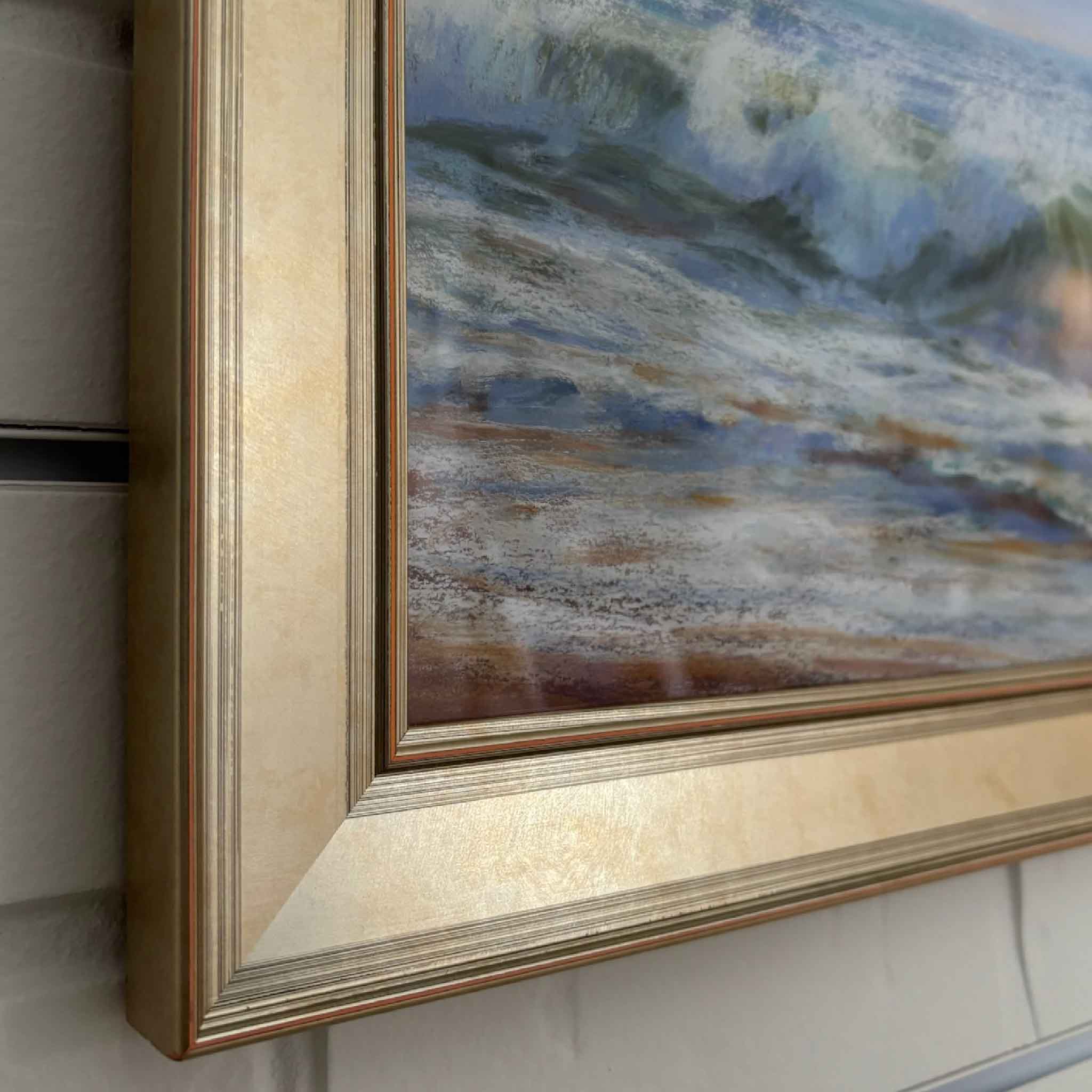 Original pastel painting of ocean waves crashing on the shore, framed in a champagne-toned frame — “Happy Dance” by Joanne Willoughby.