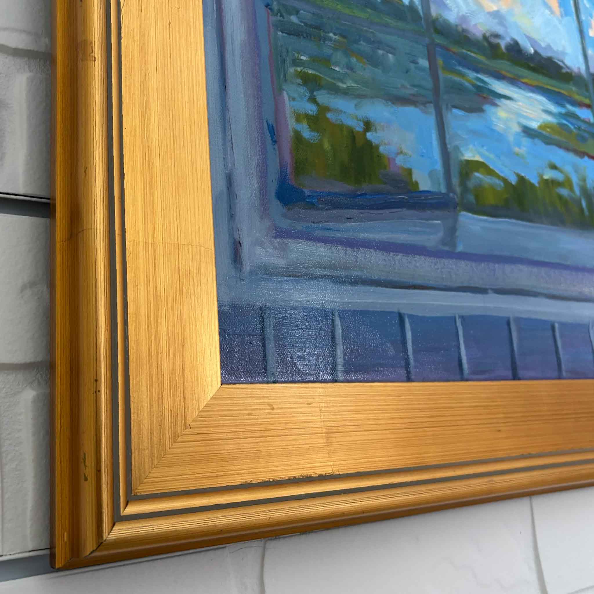 "View from Window" oil painting by Kathy Robinson in gold frame, featuring serene Lowcountry marsh scene viewed through an open window.