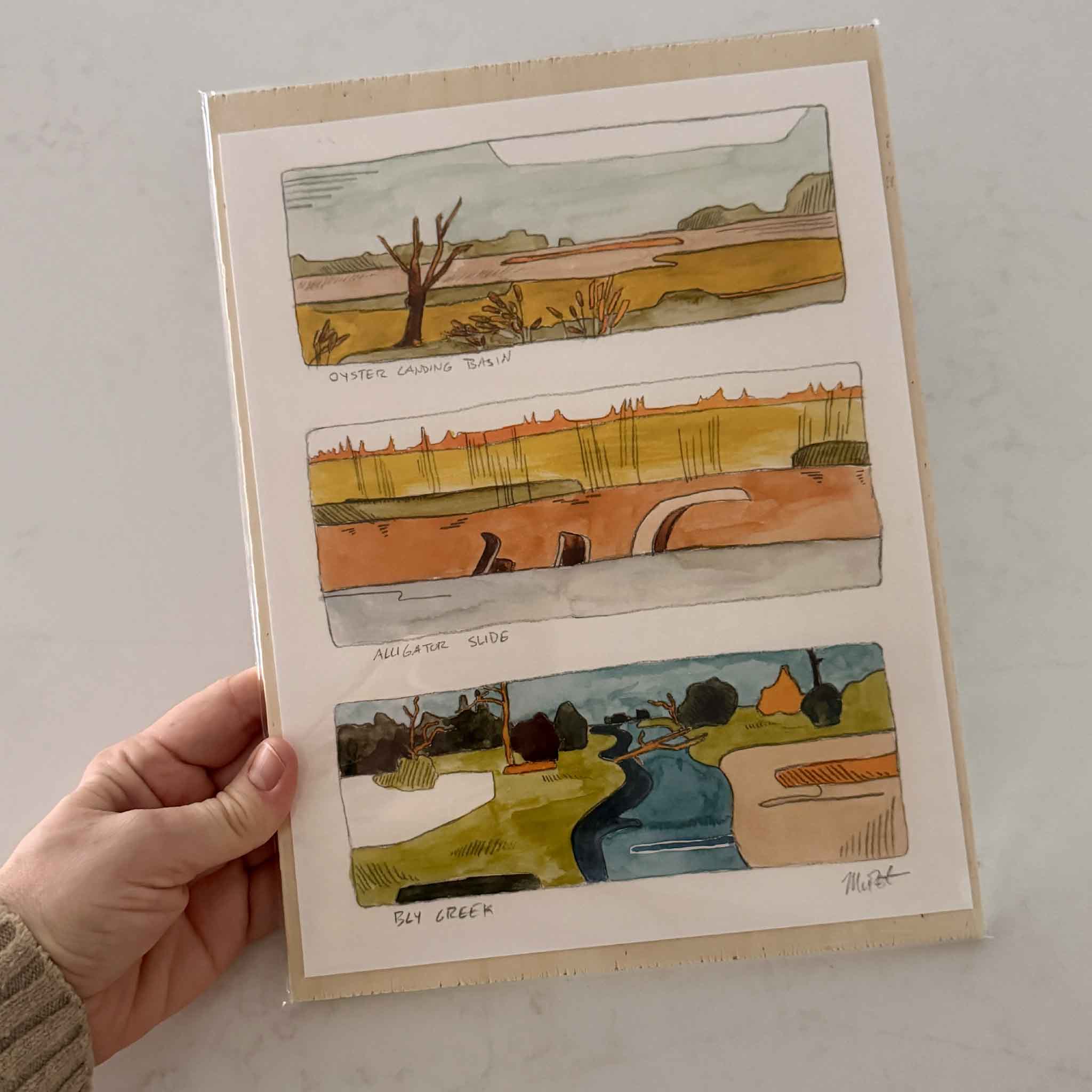 North Inlet Marsh Triptych” giclée print by Maggie Pelton featuring three marsh scenes—Oyster Landing Basin, Alligator Slide, and Bly Creek—painted in earthy greens, oranges, and blues on archival cotton paper, 8.5x11.