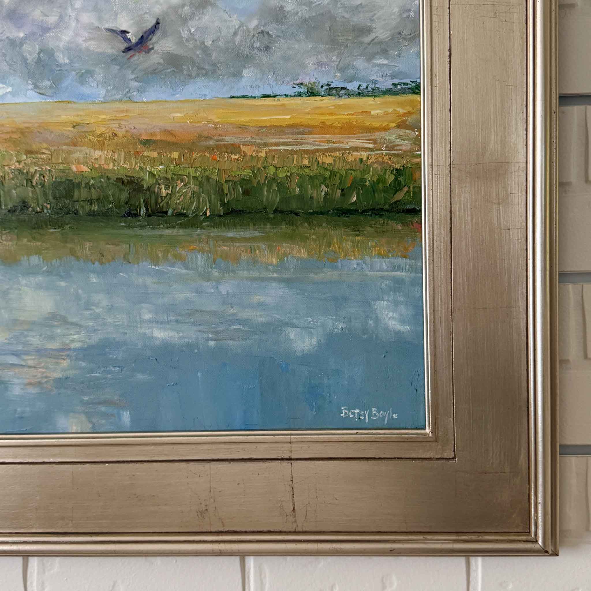 Golden oil painting by Betsy Boyle, framed South Carolina marsh landscape with golden grasses, blue sky, and flying bird, Lowcountry coastal artwork exclusive to Gray Man Gallery