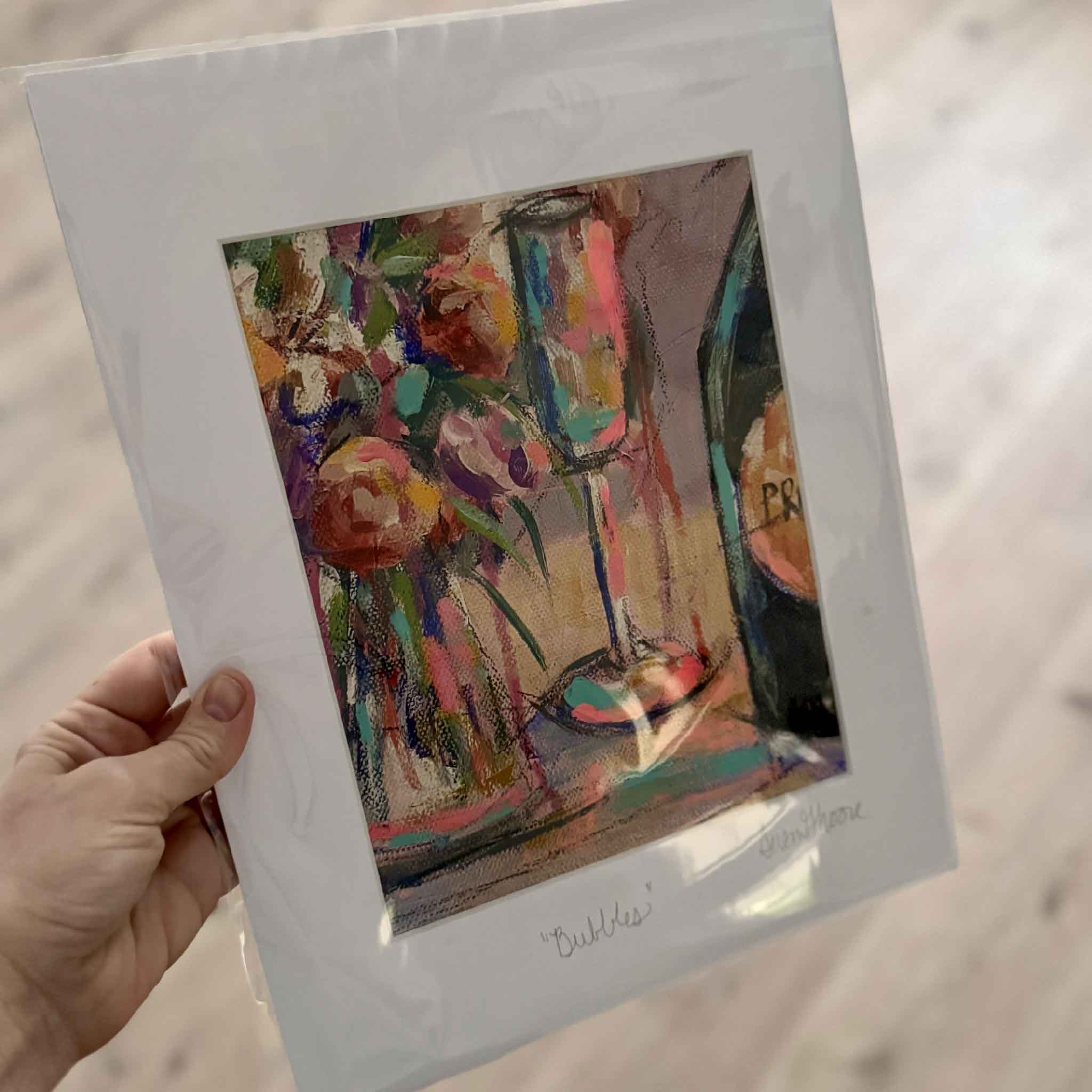 11x14 matted fine art giclée print Bubbles by Susan Moore featuring a champagne glass, floral bouquet, and bottle painted in expressive, colorful brushstrokes.
