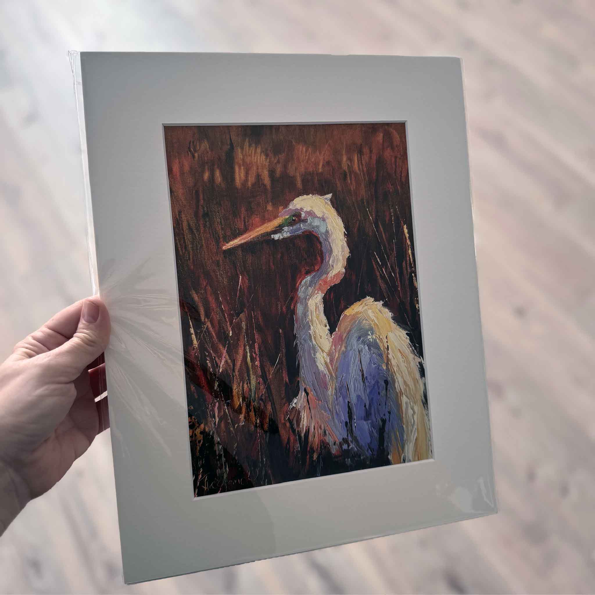 Matted art print of Golden Marsh Light by Jeanne O’Neal, featuring a colorful coastal bird standing in warm golden marsh grasses, painted in expressive brushstrokes.