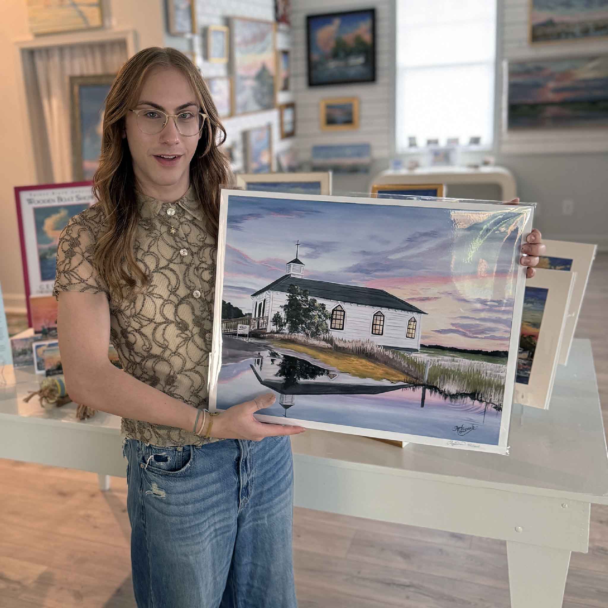 Artwork of the Pawleys Island Chapel at sunset with its reflection in the marsh, coastal print by artist April Bensch. Pictured at Gray Man Gallery.