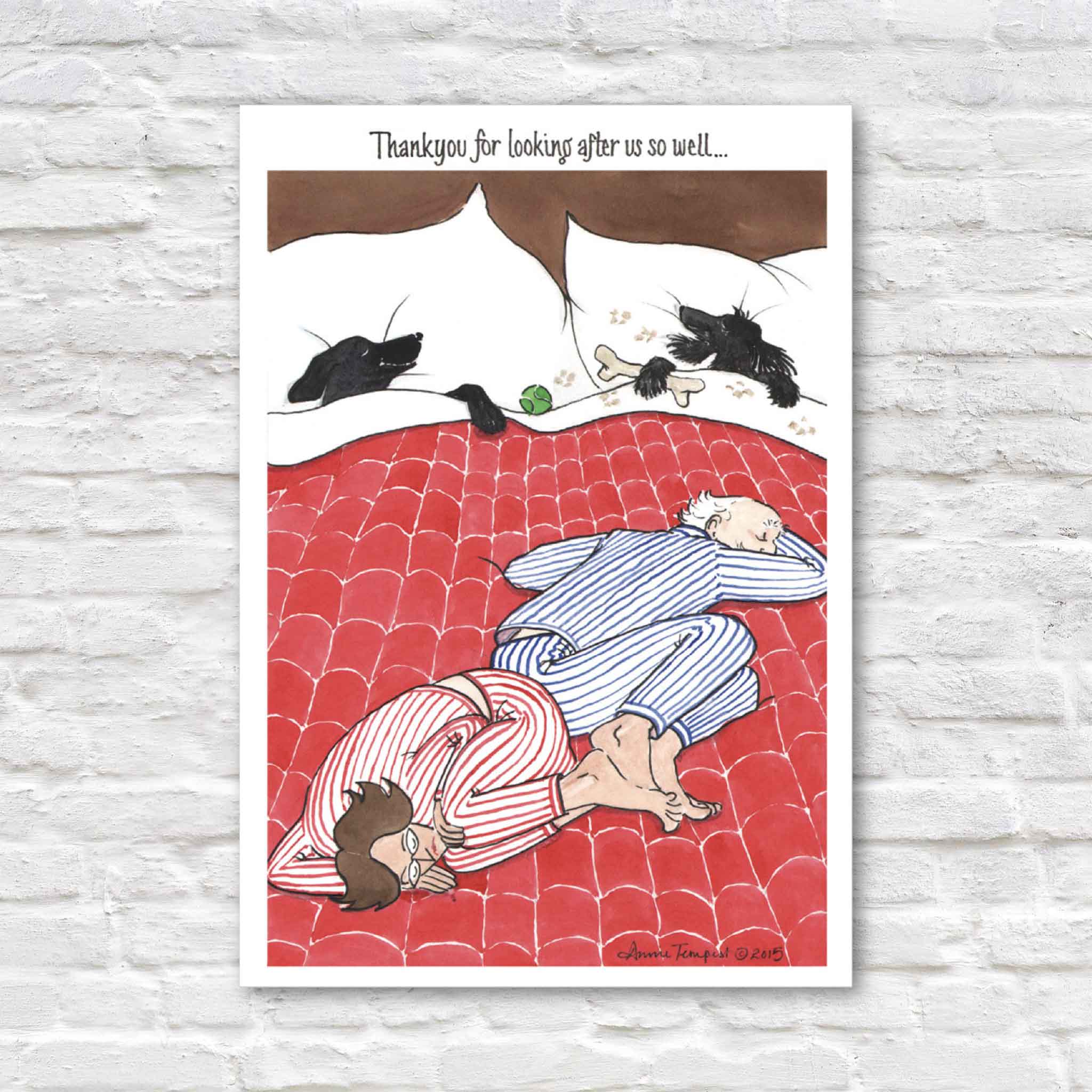Annie Tempest "Foot of the Bed" blank greeting card published by Caspari featuring two dogs relaxing comfortably in bed while their owners sleep at the edge beneath the humorous caption, "Thank you for looking after us so well…". Premium 5x7 folded greeting card with matching envelope available at Gray Man Gallery in Pawleys Island, South Carolina.
