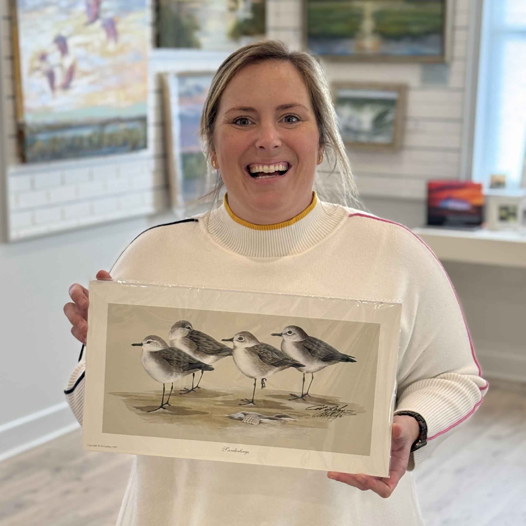 Art LaMay “Sanderlings” signed limited-edition shorebird print held inside Gray Man Gallery in Pawleys Island, South Carolina, featuring coastal bird artwork by a local artist, matted fine art print available at Gray Man Gallery
