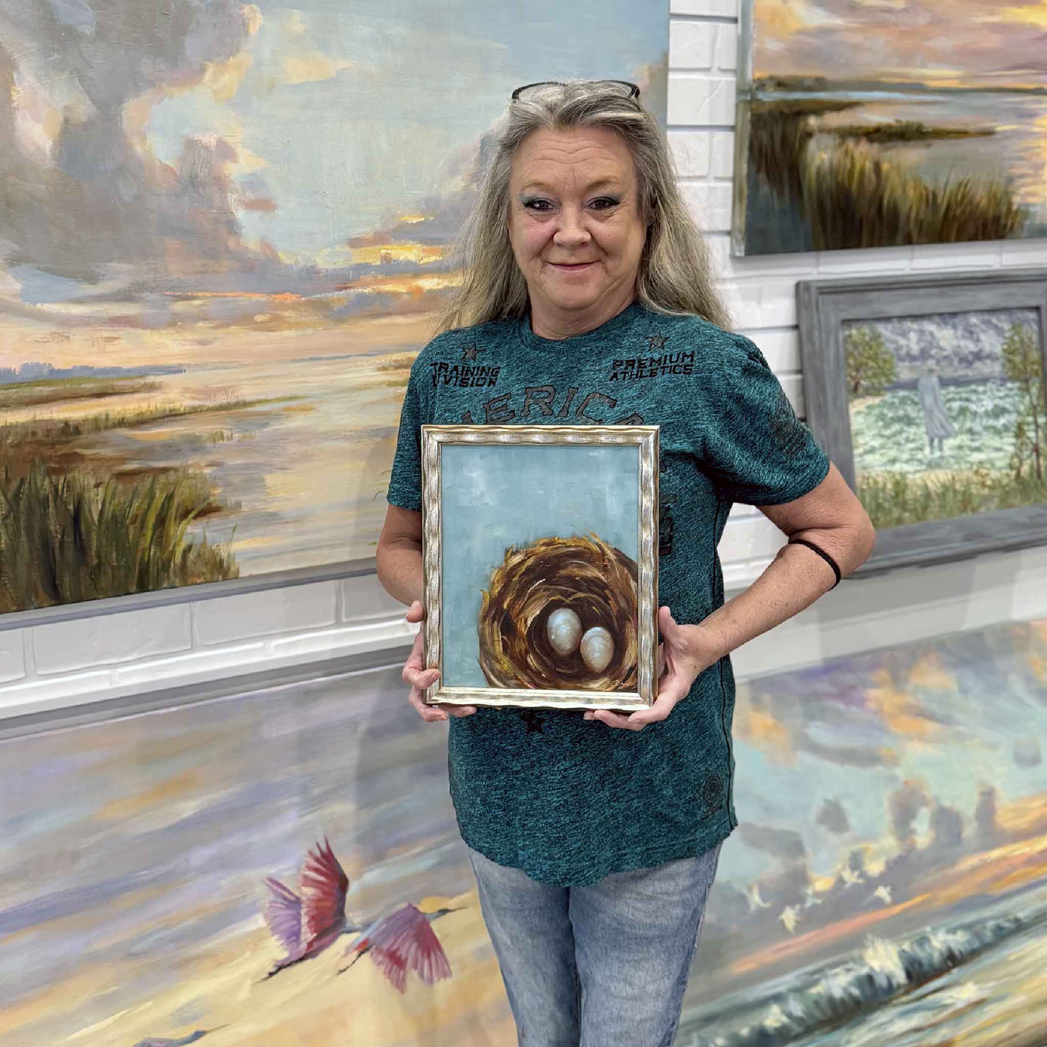 GMG team member holding the Best Nest painting to show the scale and size of the framed 8x10 original.