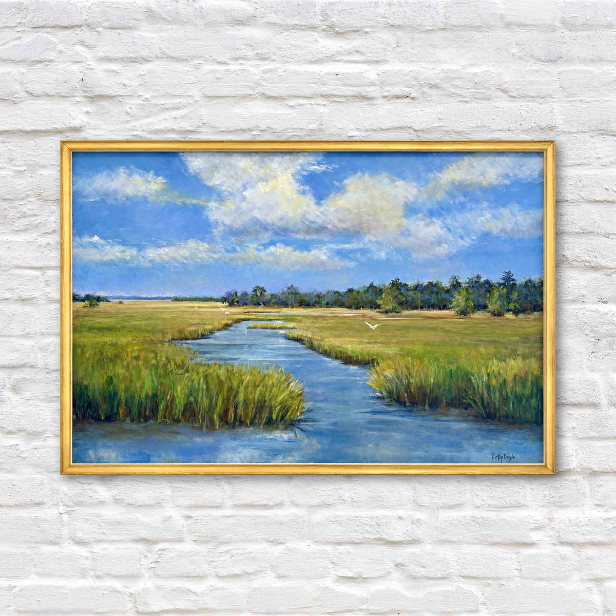 Marsh Life original oil painting by local South Carolina artist Betsy Boyle featuring a winding blue tidal creek through green Lowcountry marsh grass, white coastal birds and expansive summer sky, framed in gold and available at Gray Man Gallery in Pawleys Island