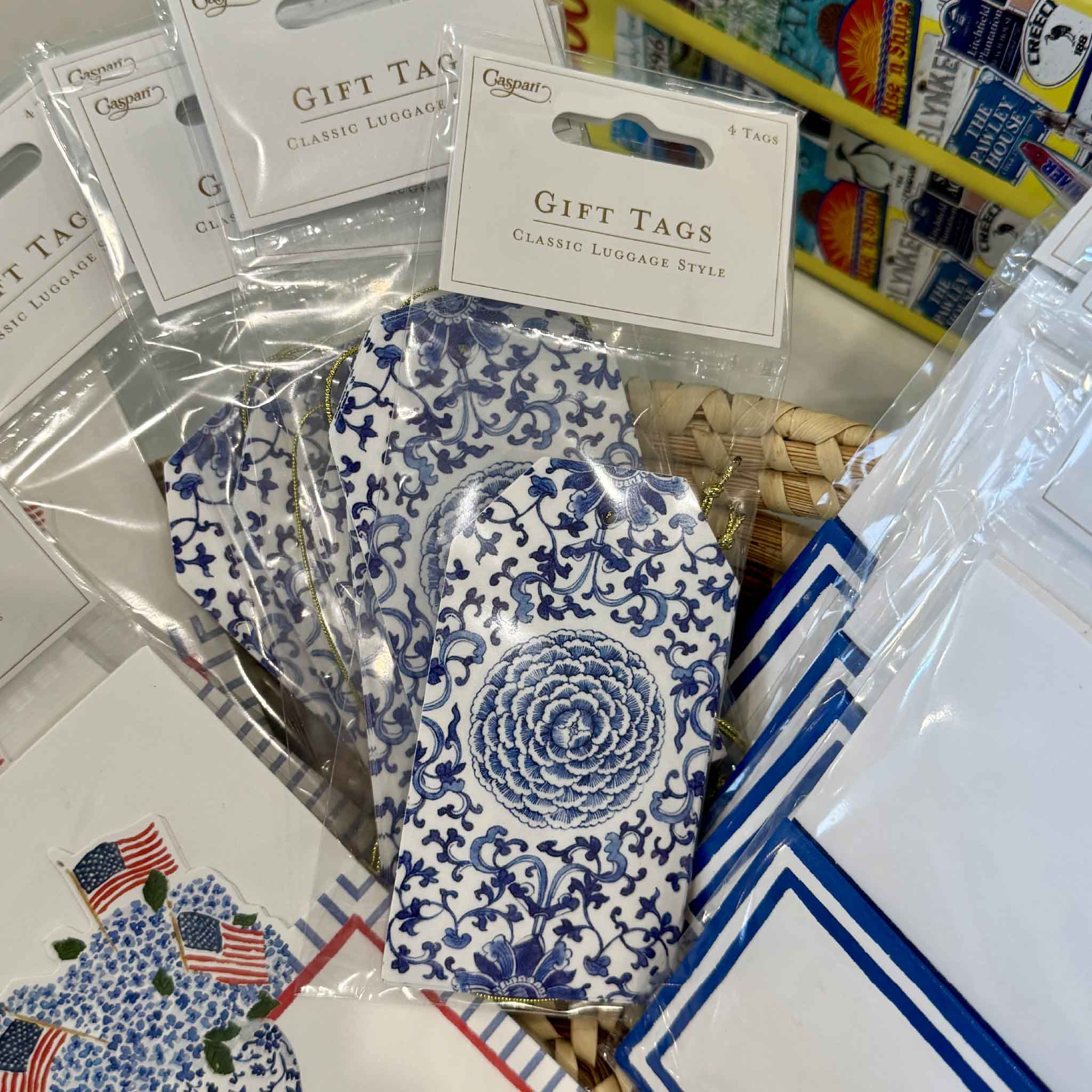 Caspari Indigo Garden decorative luggage-style gift tags displayed with coordinating place cards and entertaining accessories at Gray Man Gallery in Pawleys Island, South Carolina, showcasing timeless blue-and-white gift wrapping ideas.