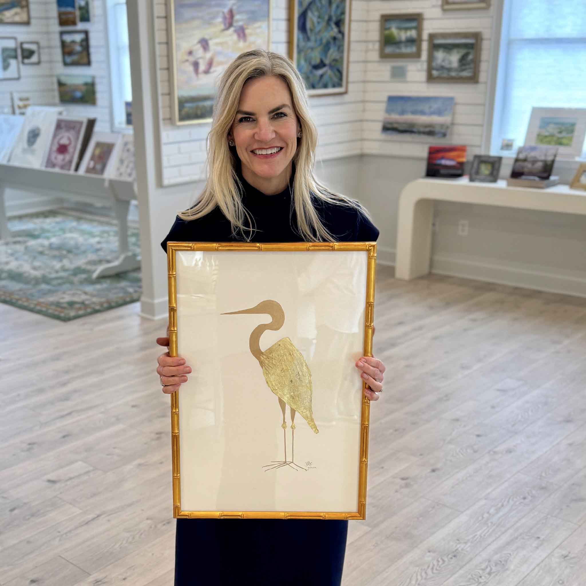 Local artist Braden Grafe Goldie heron artwork with gold leaf detail displayed in Gray Man Gallery in Pawleys Island, minimalist coastal piece with clean composition, neutral tones, and reflective metallic surface