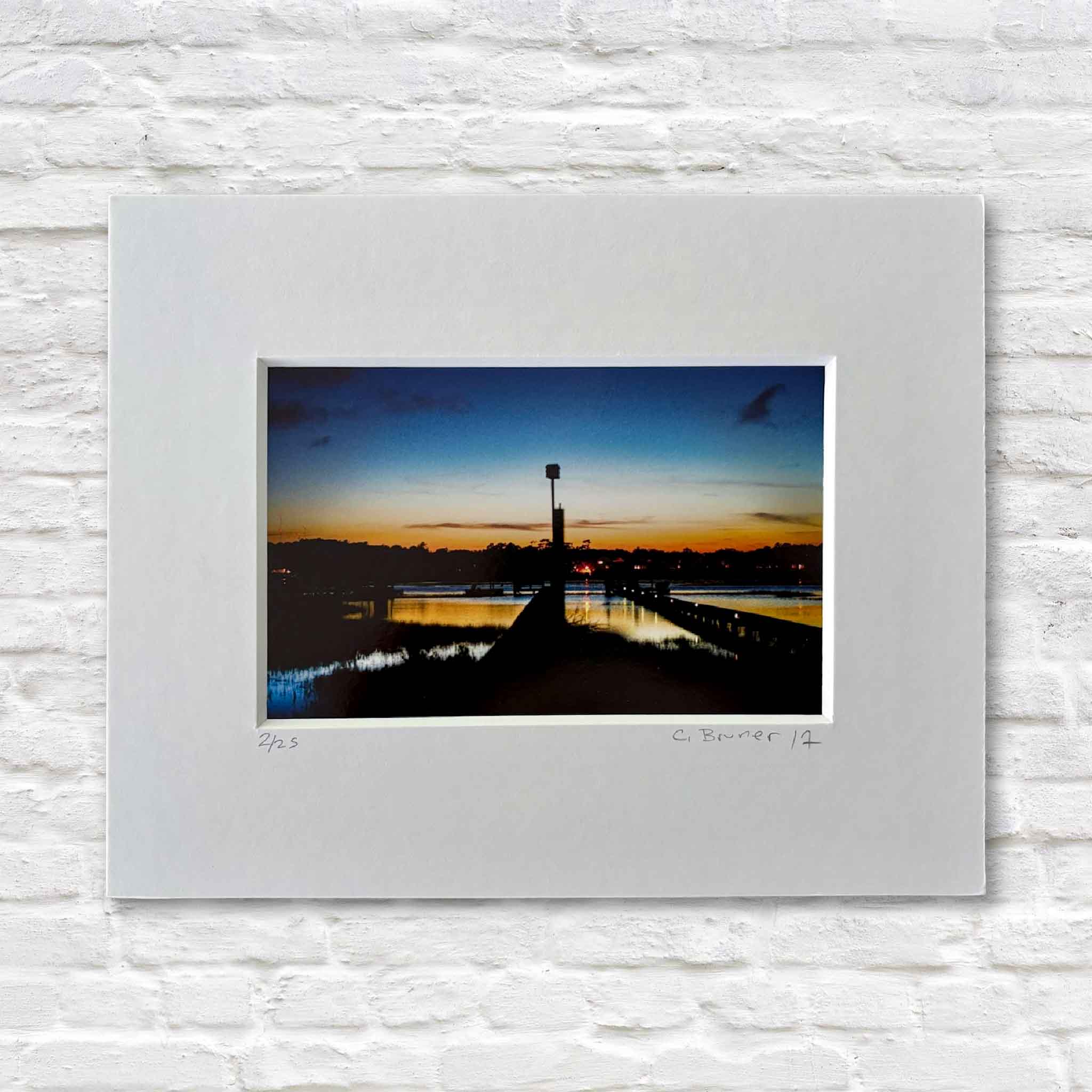 Carolina #116 coastal sunset photograph by Chris Bruner showing a Pawleys Island dock and water tower at dusk, professionally matted.