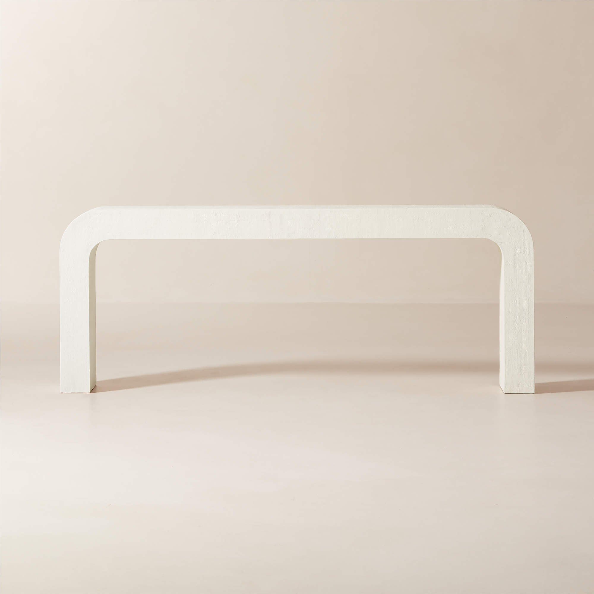 CB2 Crescent 80 inch ivory resin console table styled as long statement entryway or sofa console featuring rounded waterfall silhouette and textured ivory finish