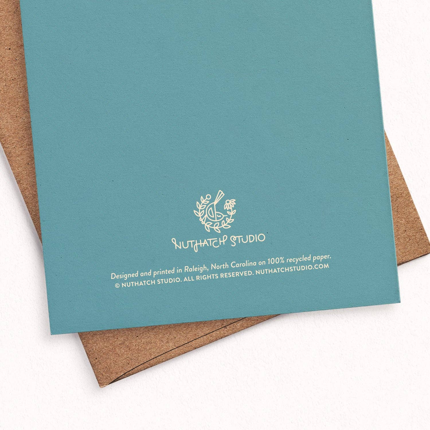 Back of the "What Are Men to Rocks and Mountains?" Jane Austen greeting card by Chrissie Van Hoever showing Nuthatch Studio branding and recycled kraft envelope. This sustainably made literary greeting card is available at Gray Man Gallery in Pawleys Island, South Carolina.