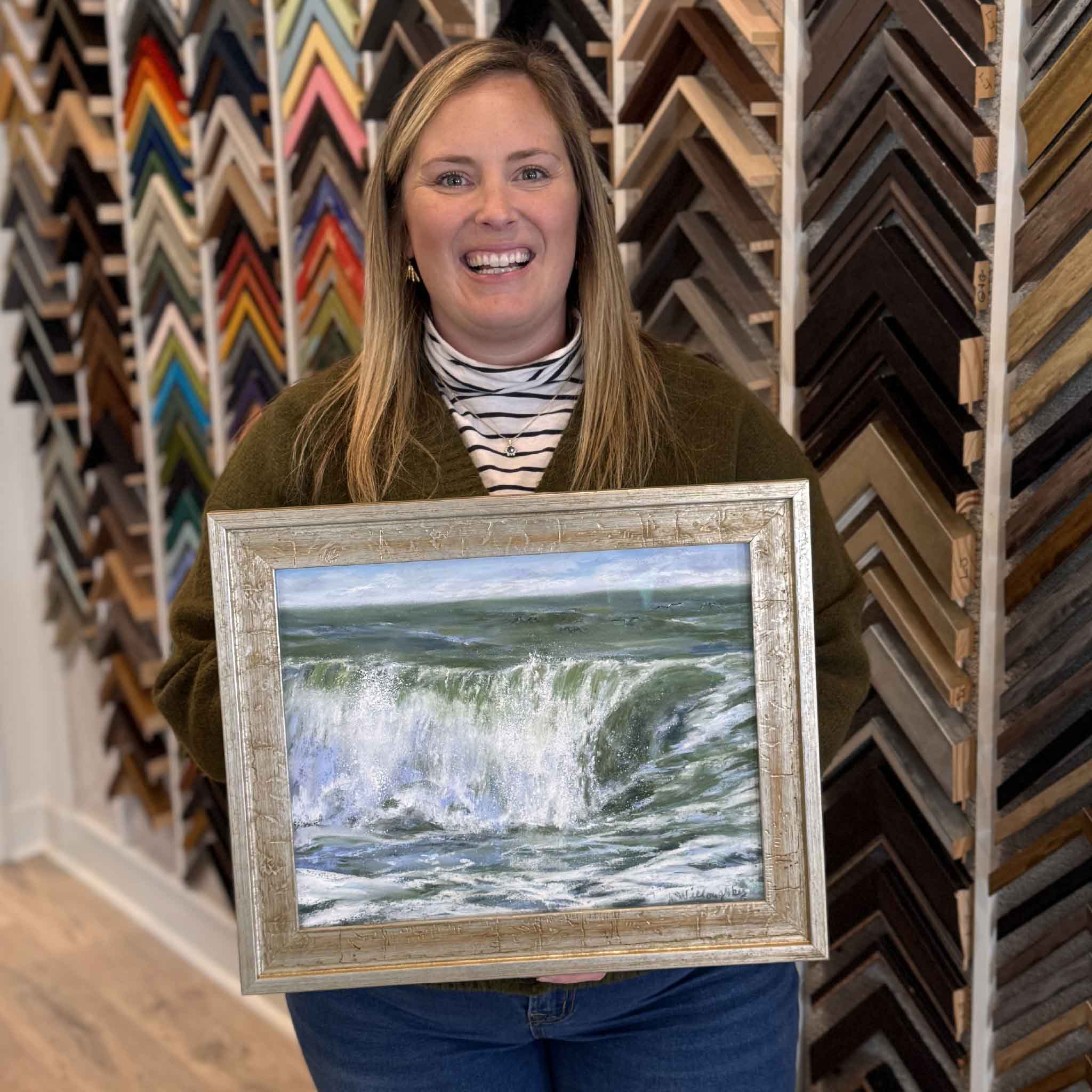 Crushin’ It by local artist Joanne Willoughby, original pastel wave painting shown framed and held inside Gray Man Gallery in Pawleys Island, SC