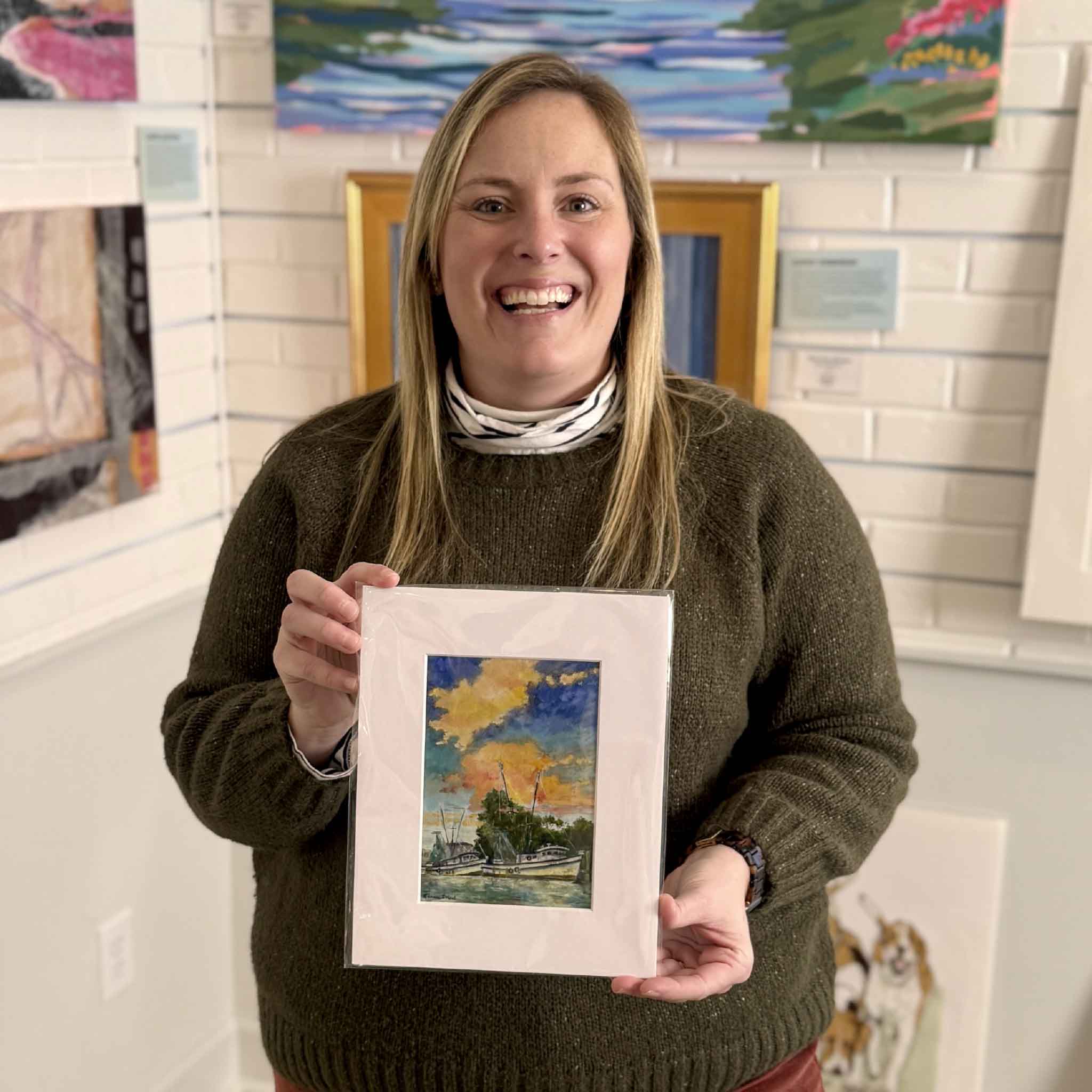 Jeanne O’Neal’s “Day’s End” harbor sunset giclée print displayed inside Gray Man Gallery in Pawleys Island, South Carolina, surrounded by local Lowcountry artwork and coastal paintings