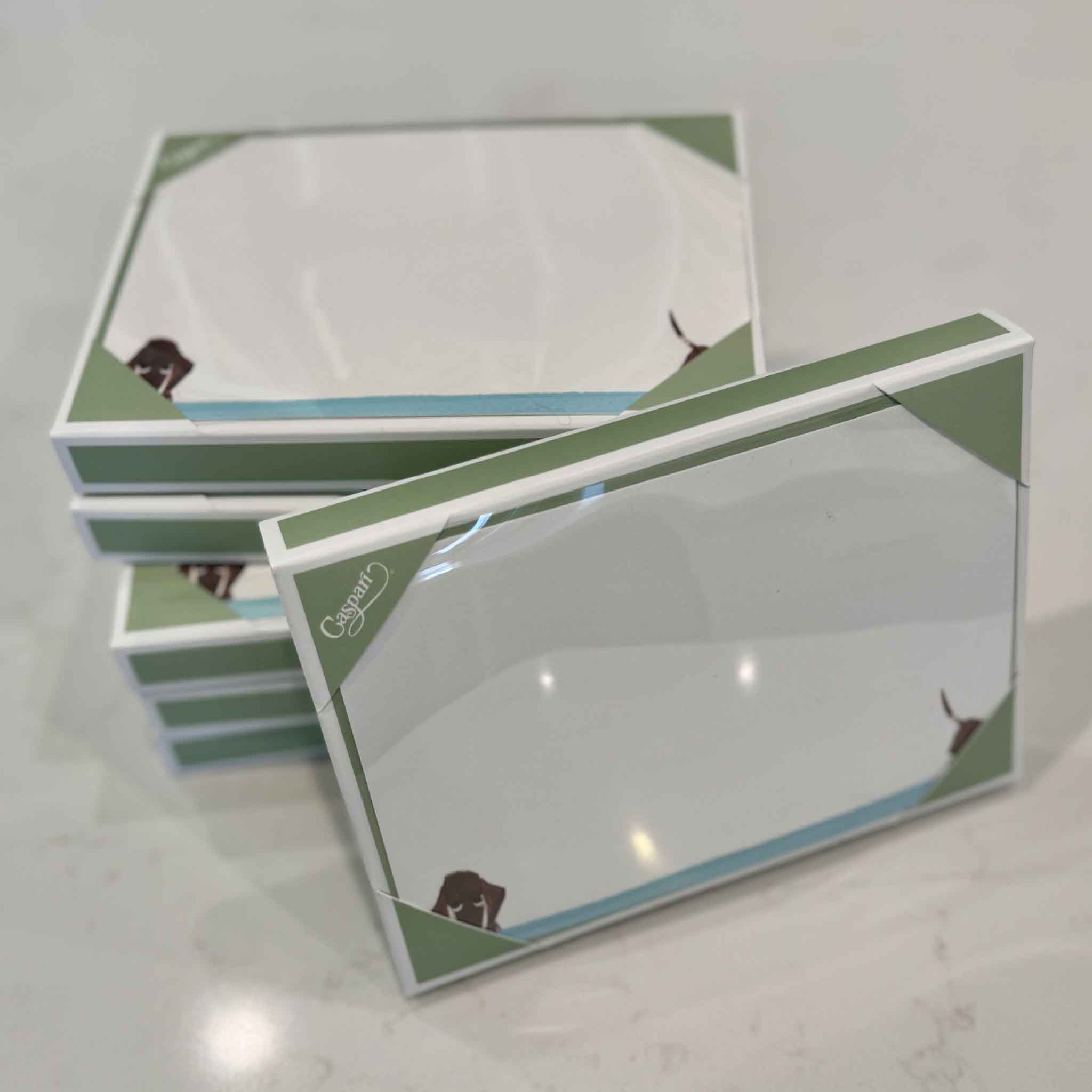 Multiple boxed sets of Doggy Paddle correspondence cards by Masaki Ryo. Each boxed stationery set includes 12 flat correspondence cards and 12 coordinating envelopes, printed in the USA and available at Gray Man Gallery in Pawleys Island.