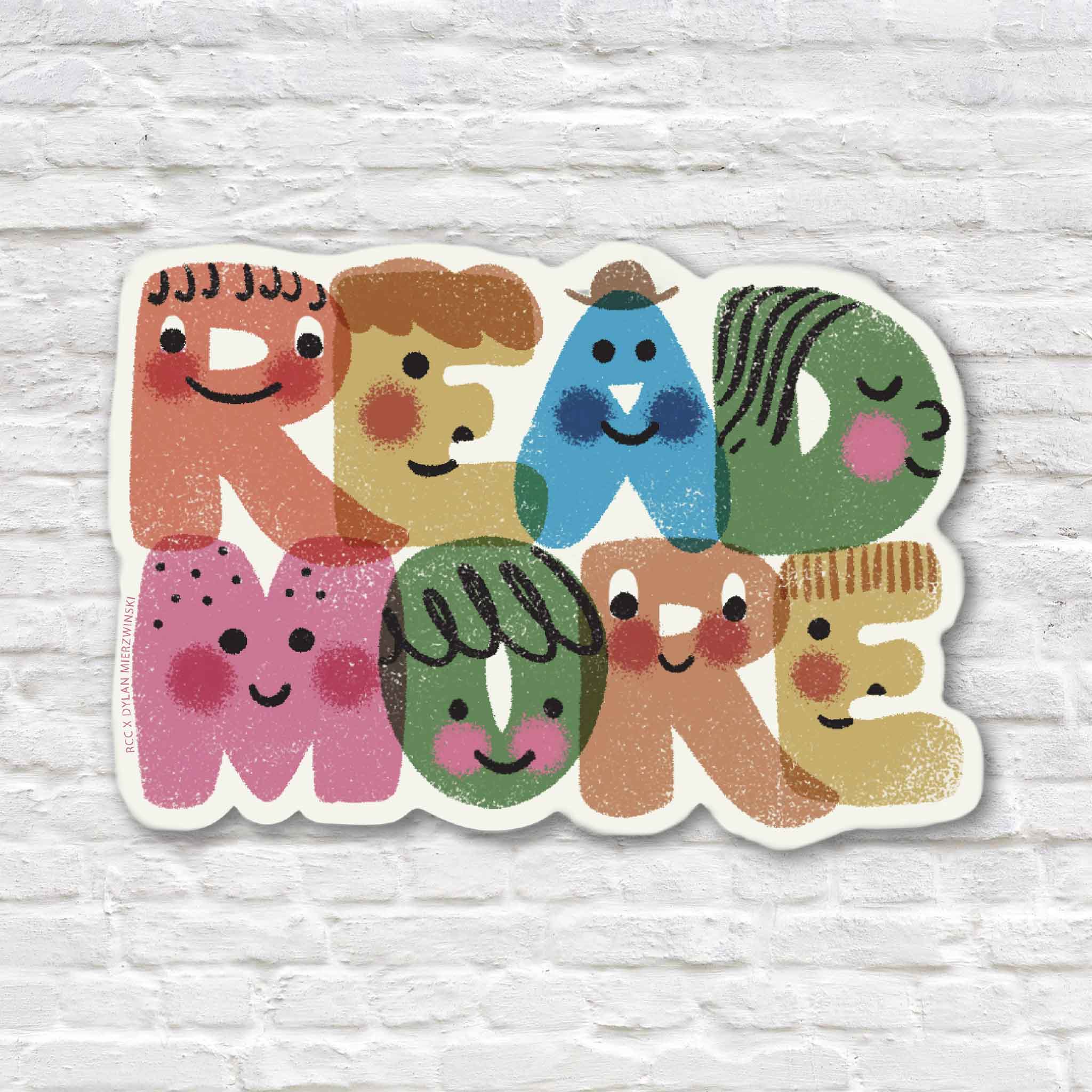 Colorful Read More vinyl sticker illustrated by Dylan Mierzwinski, featuring playful smiling letter characters in pink, coral, yellow, blue and green, photographed at Gray Man Gallery in Pawleys Island, South Carolina.