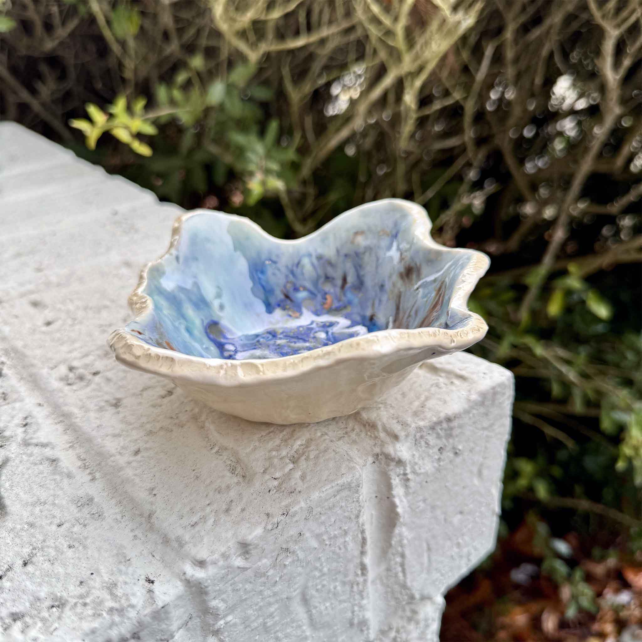 One-of-a-kind Seaspray pottery bowl I by Vida Miller with swirling blue and coastal-inspired glaze. Pictured at Gray Man Gallery.