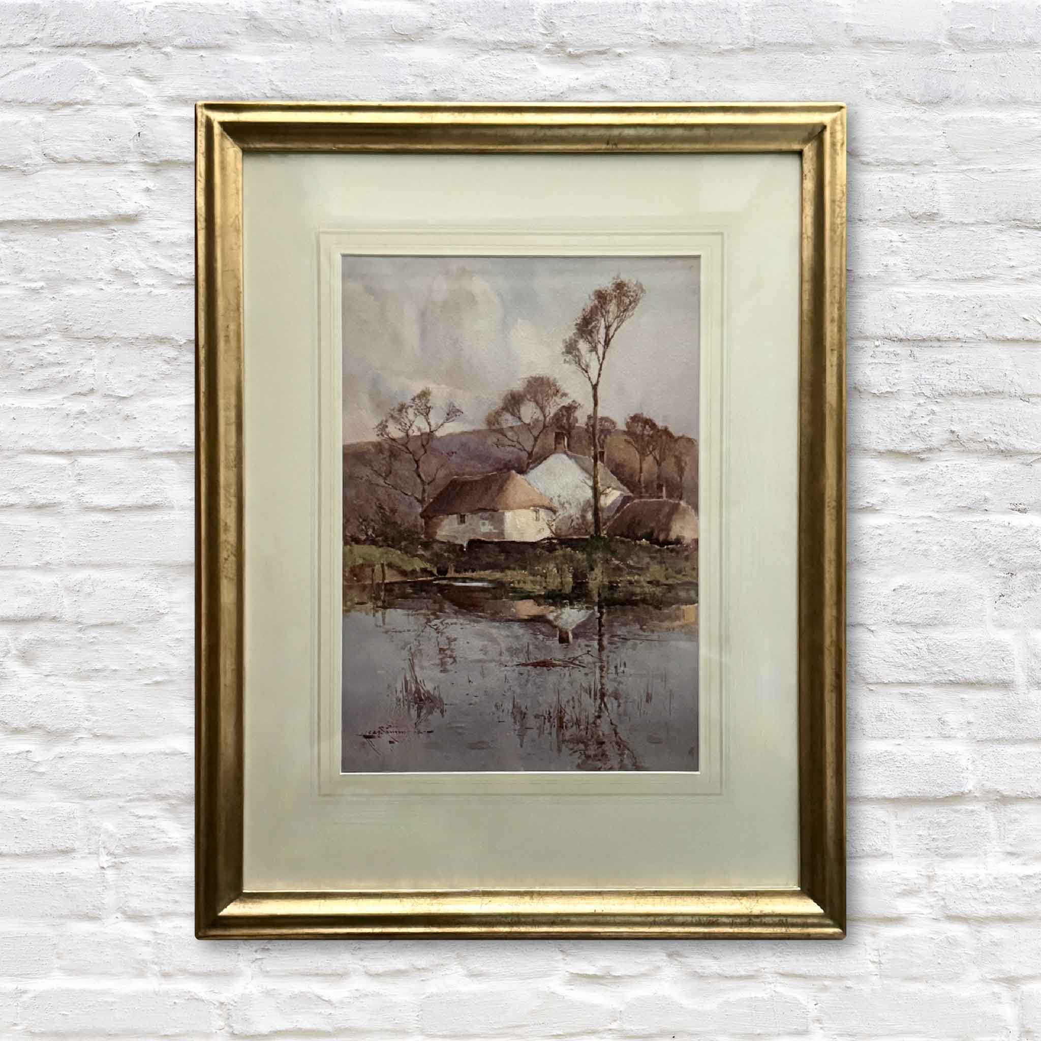 Holding the Light, an original watercolor by Charles Eyres Simmons, depicting a quiet countryside cottage reflected in still water, framed in gold with a traditional French mat.
