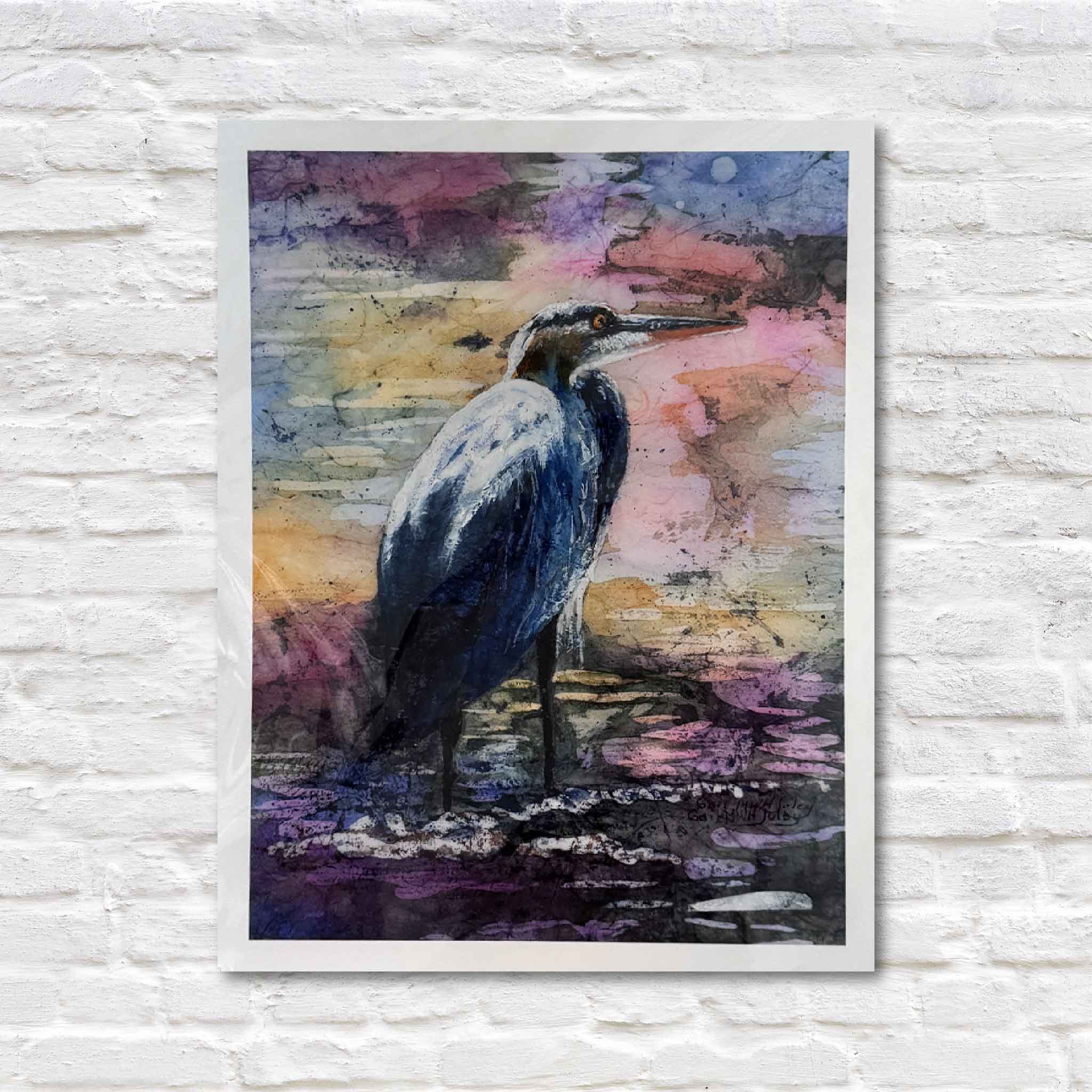 Great Blue Heron Looking for Lunch batik print by Gail Joley, featuring a blue heron standing in shallow water with layered purples, blues, and gold tones, photographed at Gray Man Gallery in Pawleys Island.