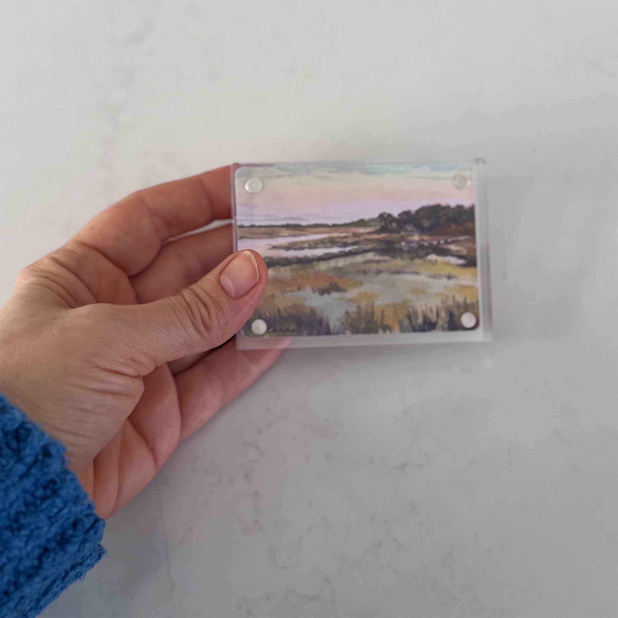 Small acrylic block art titled Blessed by Jeanne O’Neal, featuring a Lowcountry marsh scene, shown held in hand for scale at Gray Man Gallery.