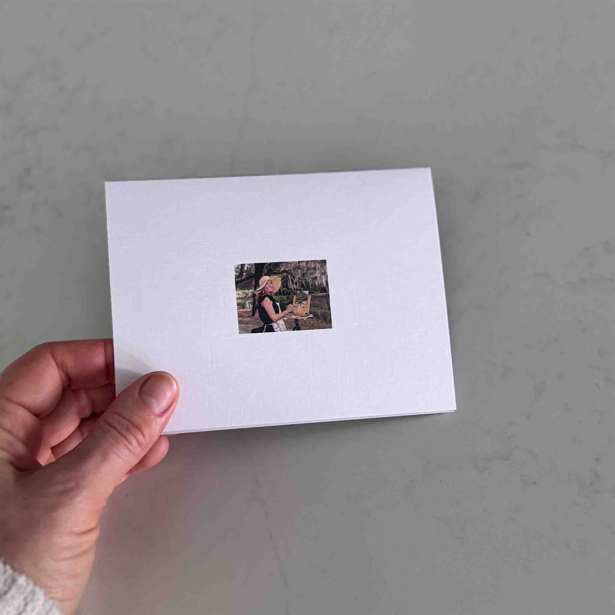 Back of a Wish You Were Here notecard featuring a small printed image of artist Jeanne O’Neal, shown on the reverse of the card.