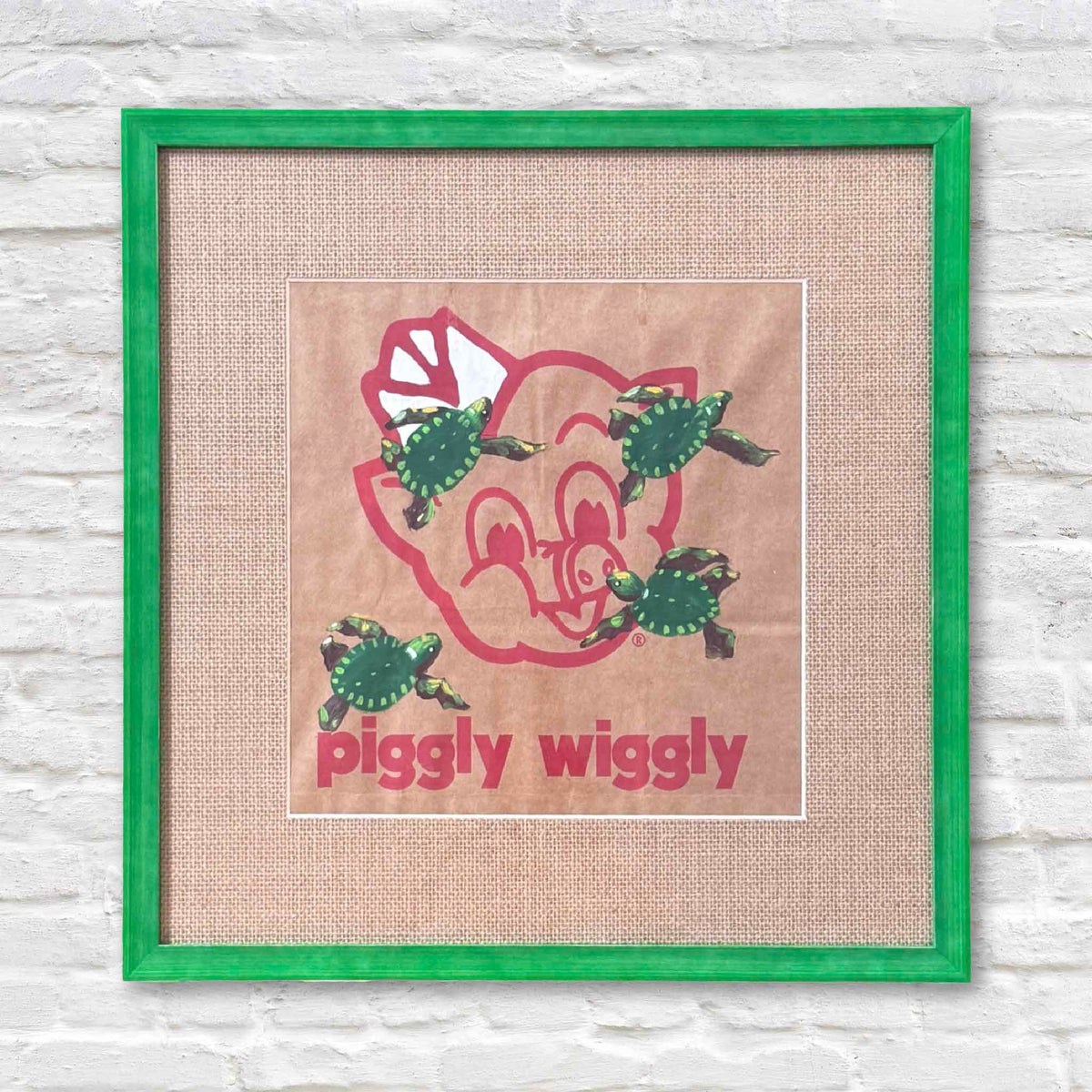 Jenny Reynolds original Piggly Wiggly turtles artwork painted on an authentic paper grocery bag, featuring green sea turtles swimming across the iconic pig logo, custom framed by Gray Man Gallery in Pawleys Island.