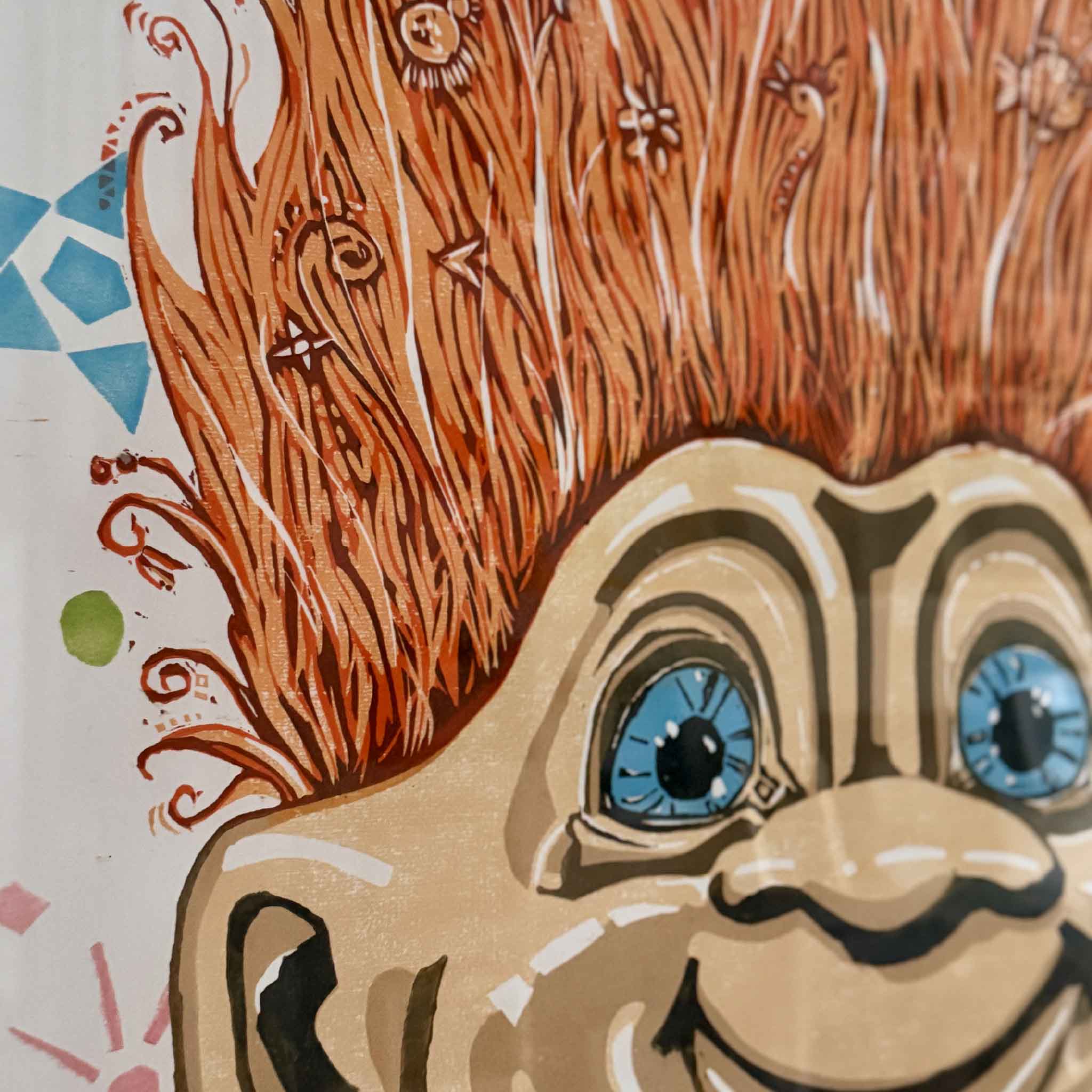 Close-up detail of Hair Up (Pumpkin) by Laurie McIntosh, highlighting the expressive linocut texture, layered inks, and whimsical orange hair created through the reduction printmaking process.