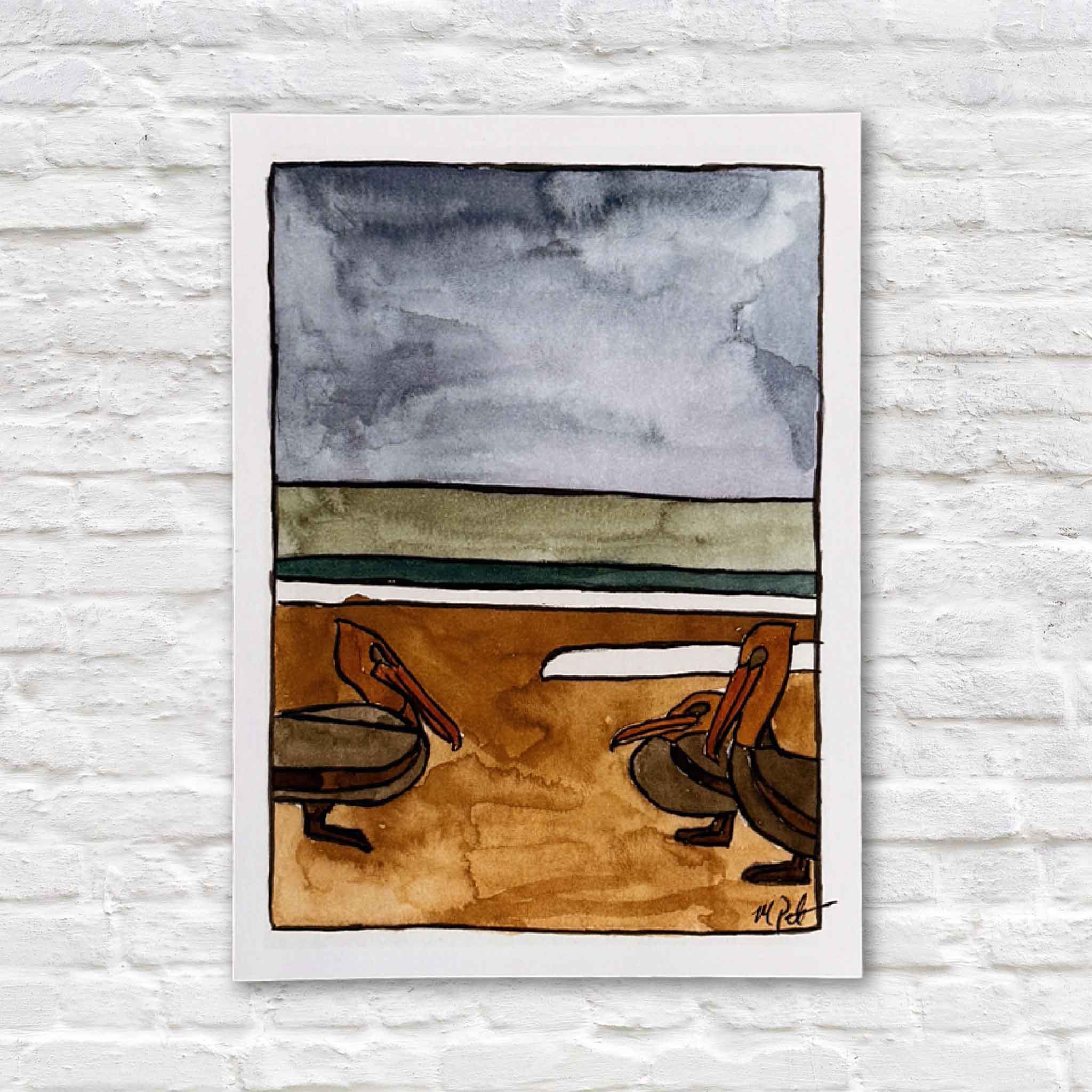 Pelican, a 5x7 giclée print by Maggie Pelton, depicting two pelicans along a sandy shoreline beneath layered coastal skies and available at Gray Man Gallery.