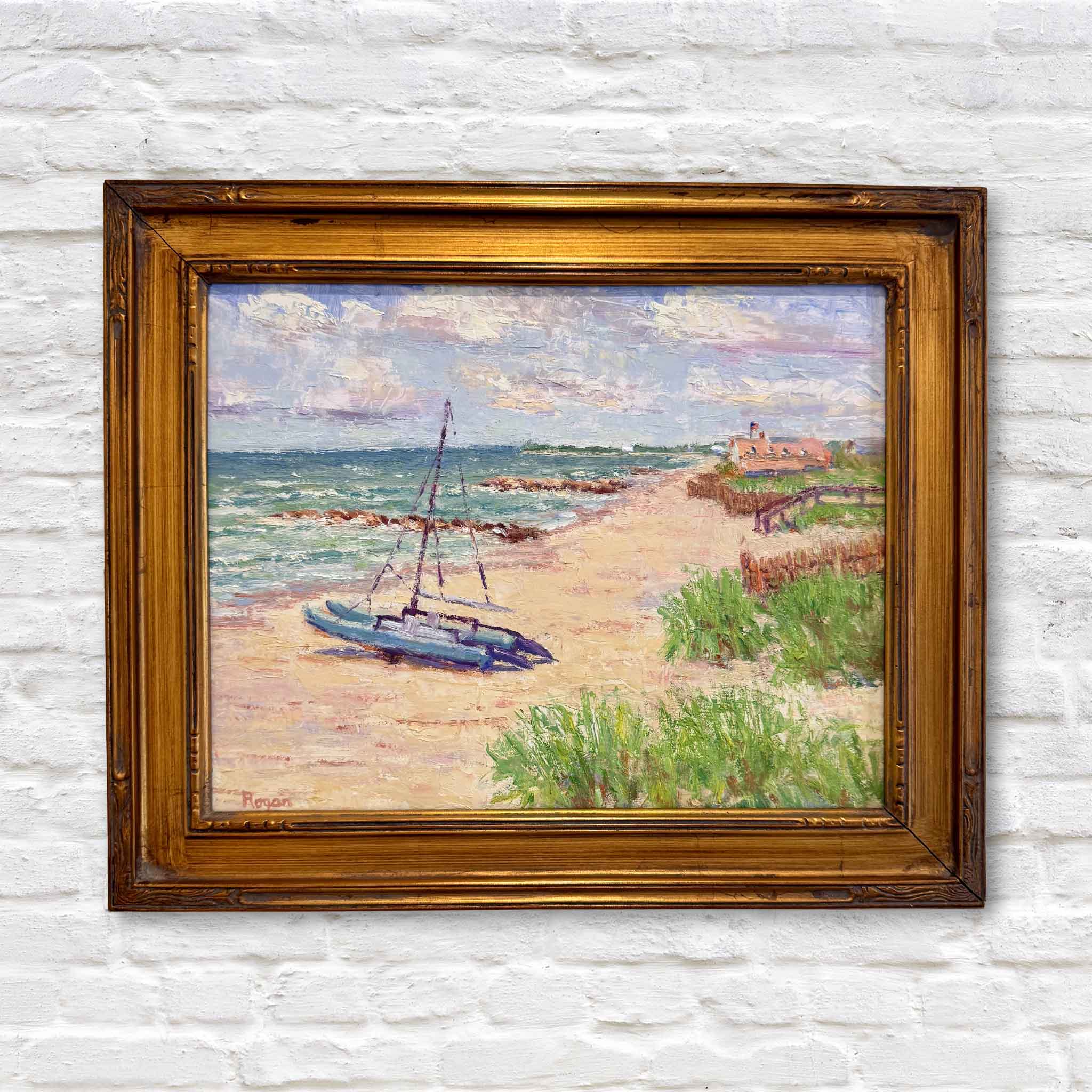 Framed original oil painting titled Catamaran on Pawleys by Michael Rogan, depicting a sunlit Pawleys Island beach with a catamaran resting near the shoreline.