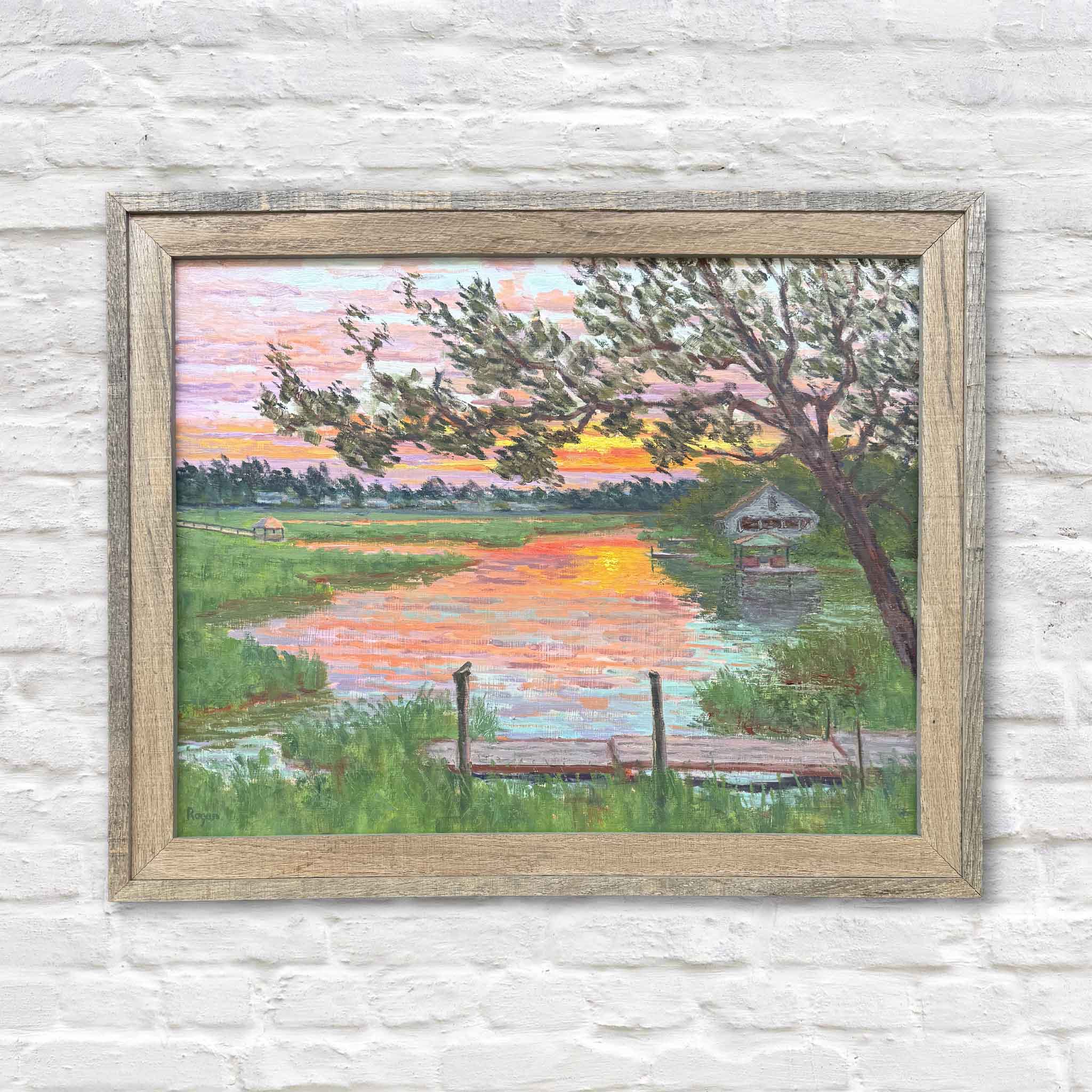 Fading Light by Michael Rogan, an original en plein air oil painting painted in South Litchfield, South Carolina, and available at Gray Man Gallery in Pawleys Island. This framed Lowcountry landscape captures a glowing marsh sunset with winding tidal creeks, a traditional rice trunk, live oak trees, and colorful reflections across the water.