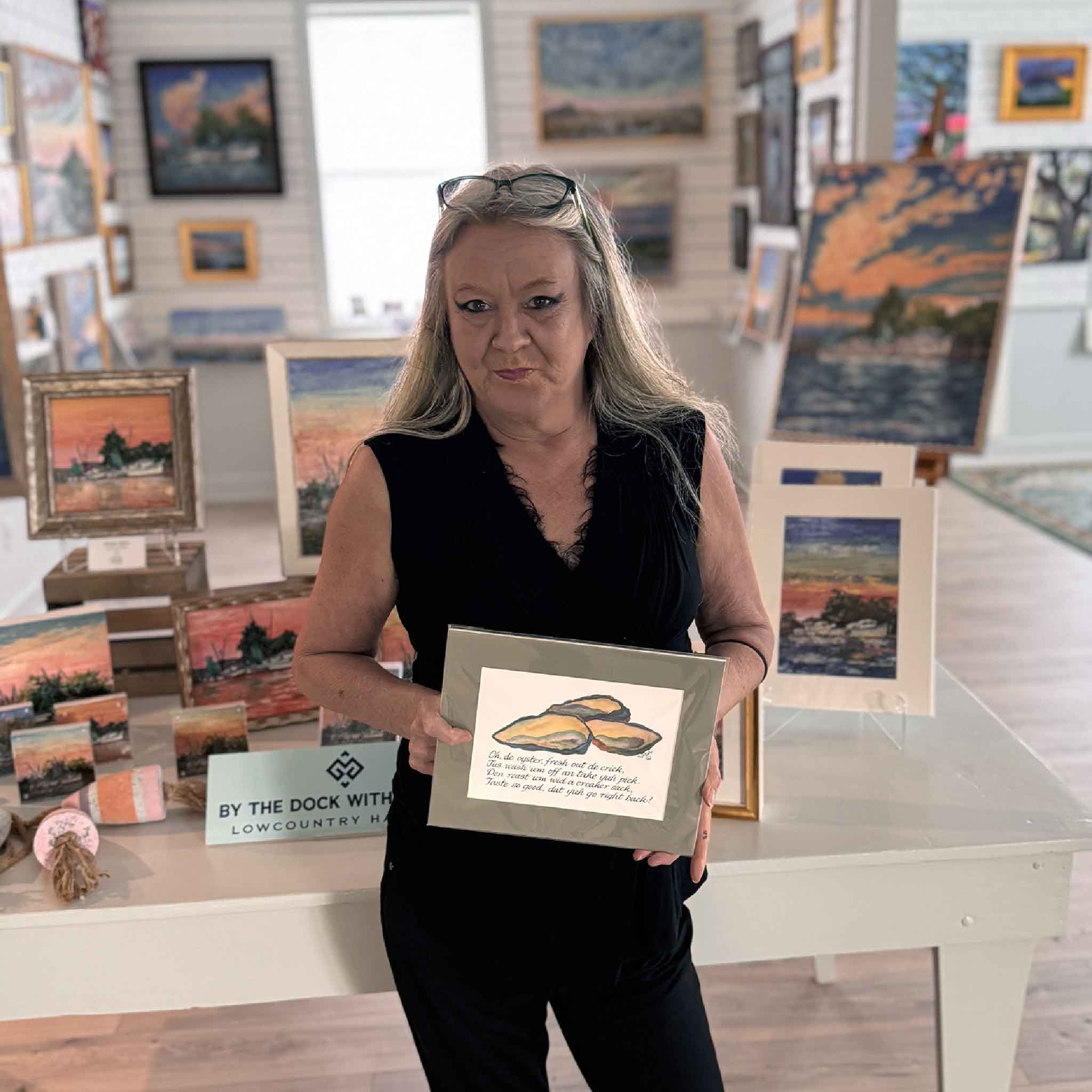 Vida Miller Gullah Odes Oyster matted art print shown held by a gallery team member at Gray Man Gallery, illustrating scale and suitability for coastal kitchens and Lowcountry homes.