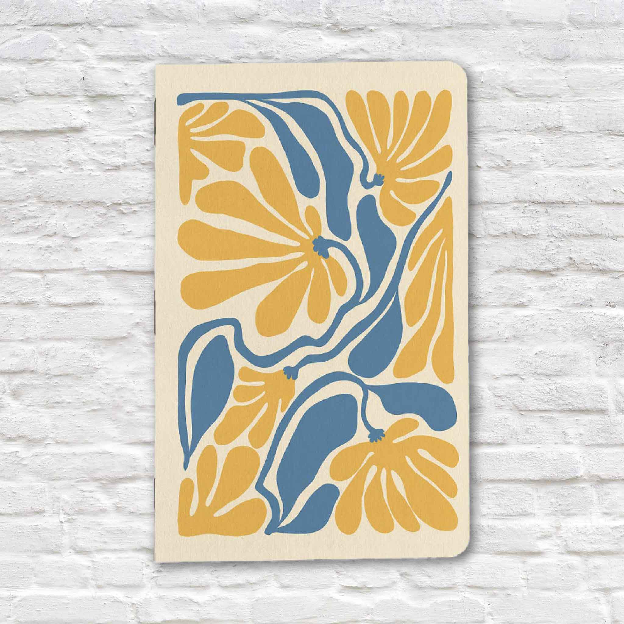 Yellow Floral Notebook by Justin Ryan Books featuring a bold boho-inspired floral design in yellow and blue. Handmade 5x7 notebook with blank pages, available at Gray Man Gallery in Pawleys Island, South Carolina.