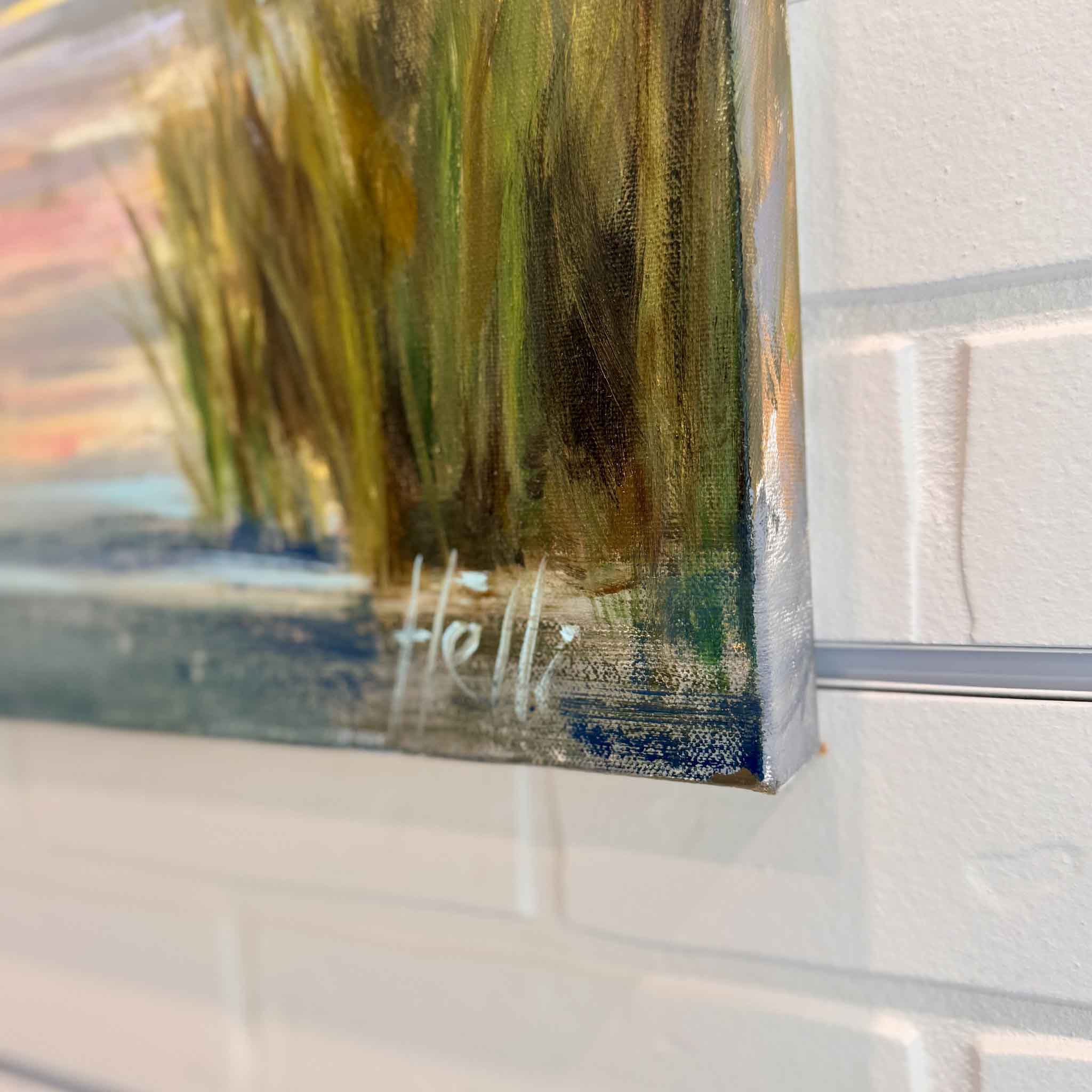 Close-up detail of “Morning Show,” an original oil painting by Helli Luck, showing gallery-wrapped canvas edges, artist signature, layered brushwork, and coastal marsh sunrise colors at Gray Man Gallery