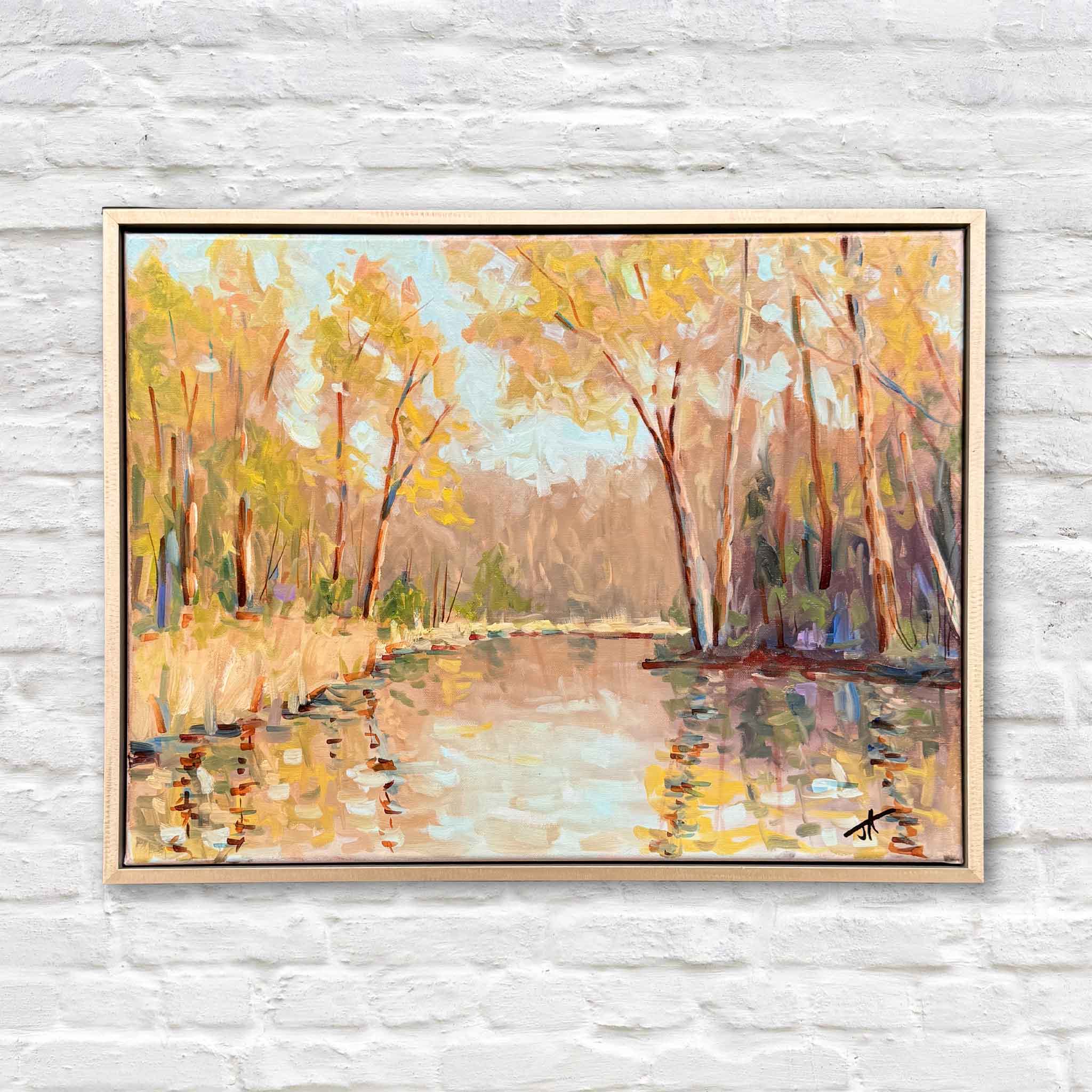 Spring Light by Jamie Arnold original oil painting featuring a tranquil landscape with reflective water, softly rendered trees, and warm golden and peach tones suggesting early spring light, shown in a custom wood frame at Gray Man Gallery in Pawleys Island, South Carolina, highlighting the artist’s expressive brushwork and layered color