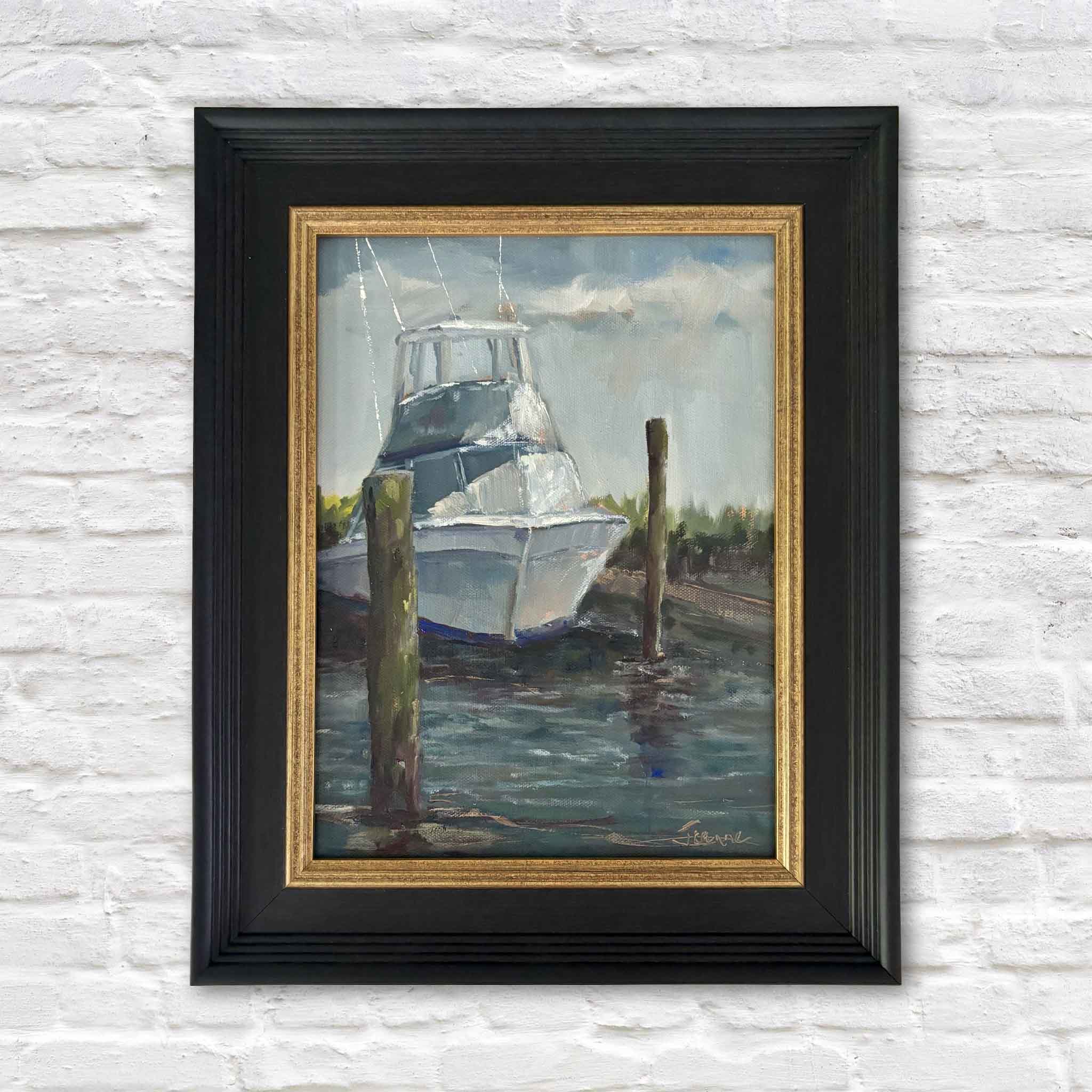 Docked for the Day by Jeanne O'Neal, an original oil painting inspired by Georgetown, South Carolina, featuring a sportfishing boat resting between weathered pilings with sunlight reflecting across the harbor water, presented in an elegant black and gold frame at Gray Man Gallery.